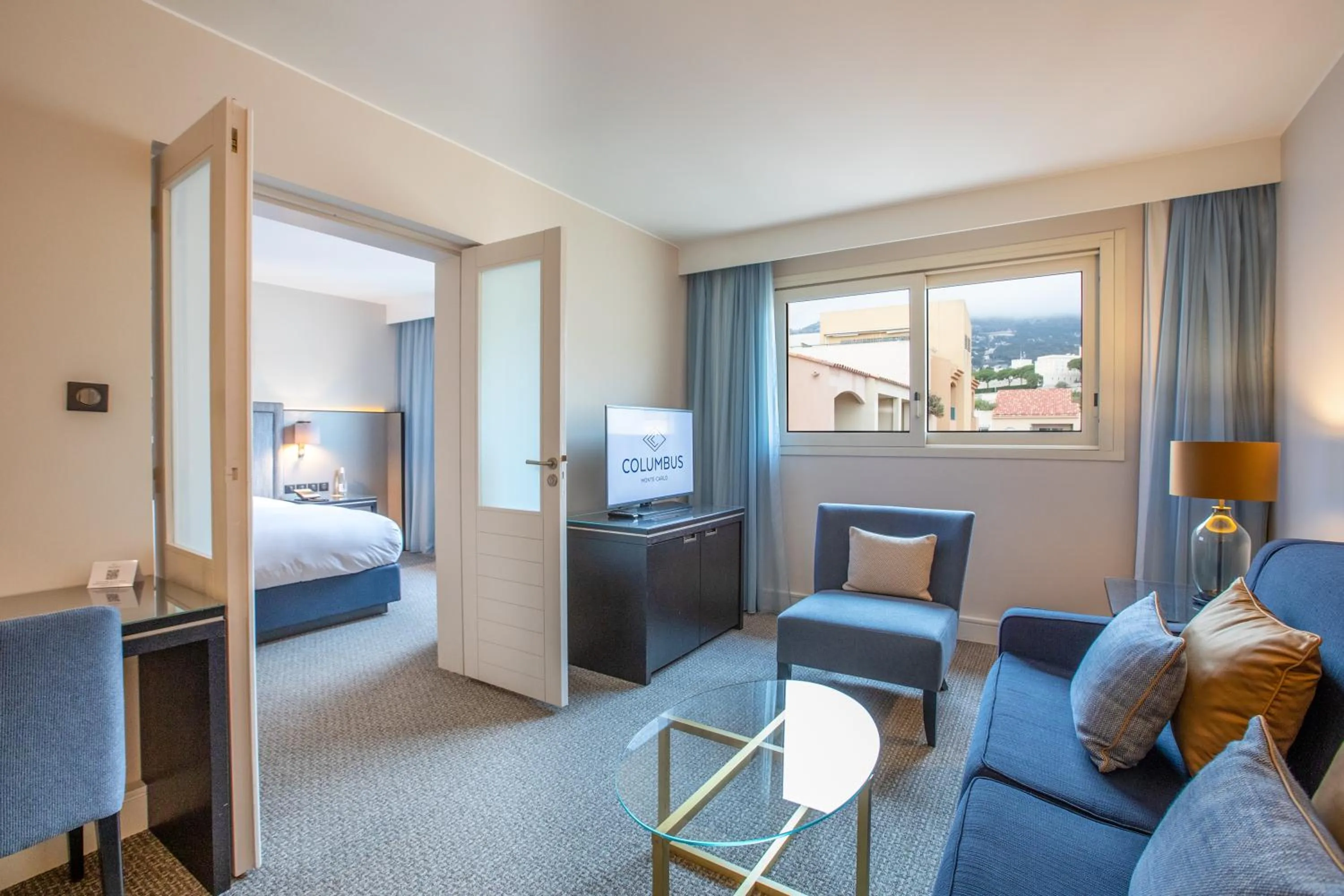 Living room, Bed in Columbus Hotel Monte-Carlo, Curio Collection by Hilton