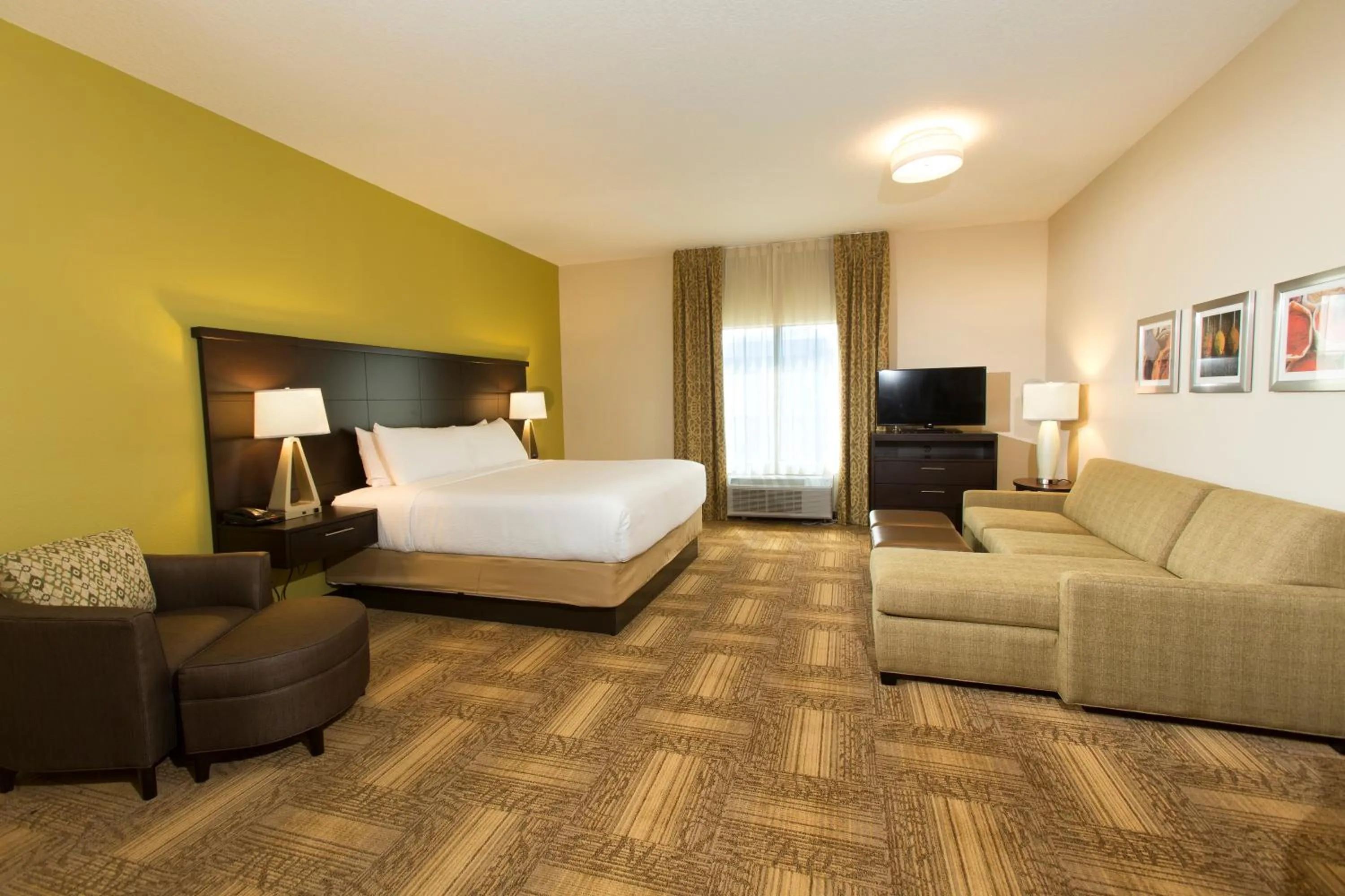 Living room, Bed in Staybridge Suites Orlando at SeaWorld by IHG - Free Breakfast & Shuttle to SeaWorld Parks