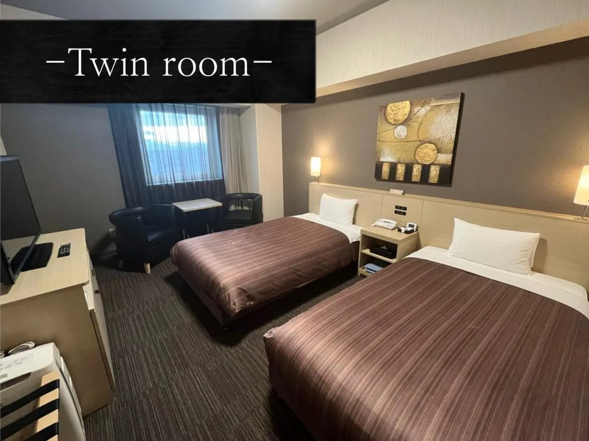 Bed in Hotel Route Inn Grand Asahikawa Ekimae