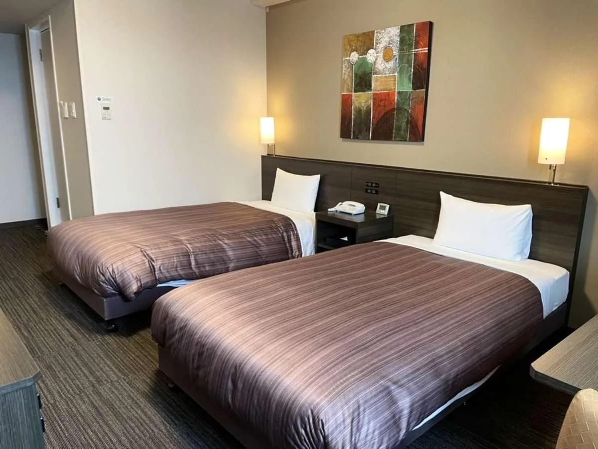 Bed in Hotel Route Inn Grand Asahikawa Ekimae