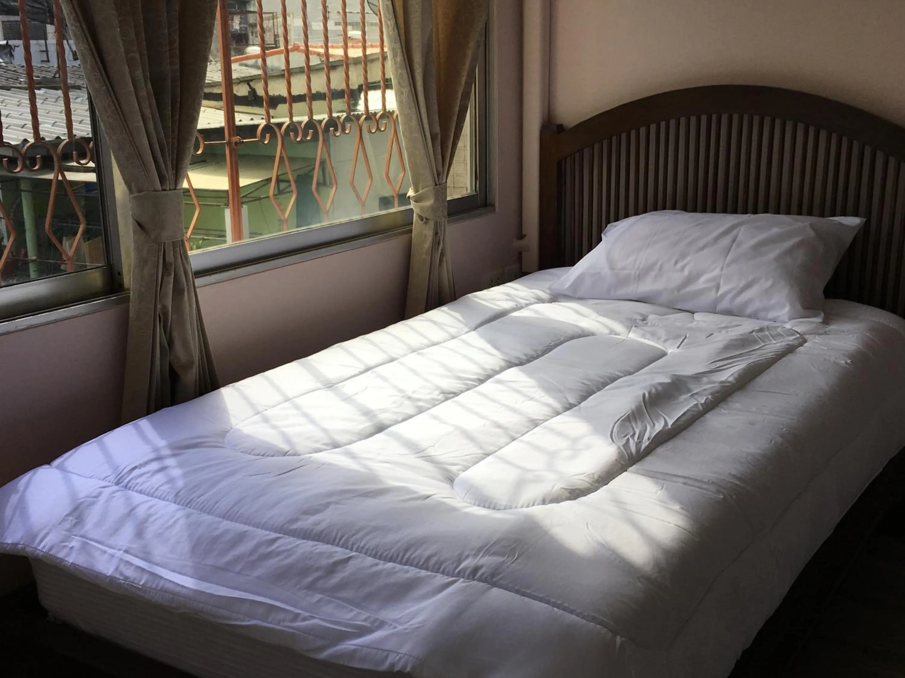 Bed in The Grand Palace Hotel