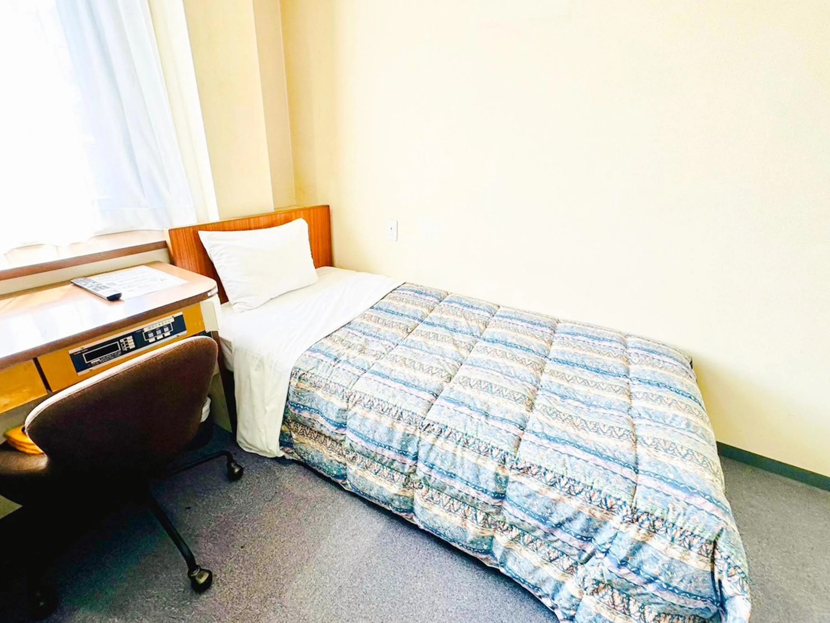 Photo of the whole room, Bed in Station Business Hotel Tenshukaku
