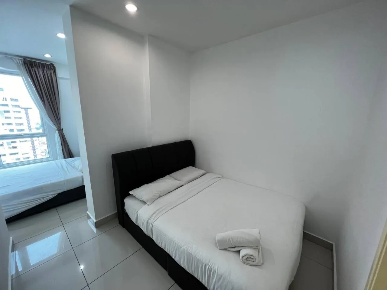 Bed in Merlene Suites at Mansion One Formerly know as Mansion One Suites