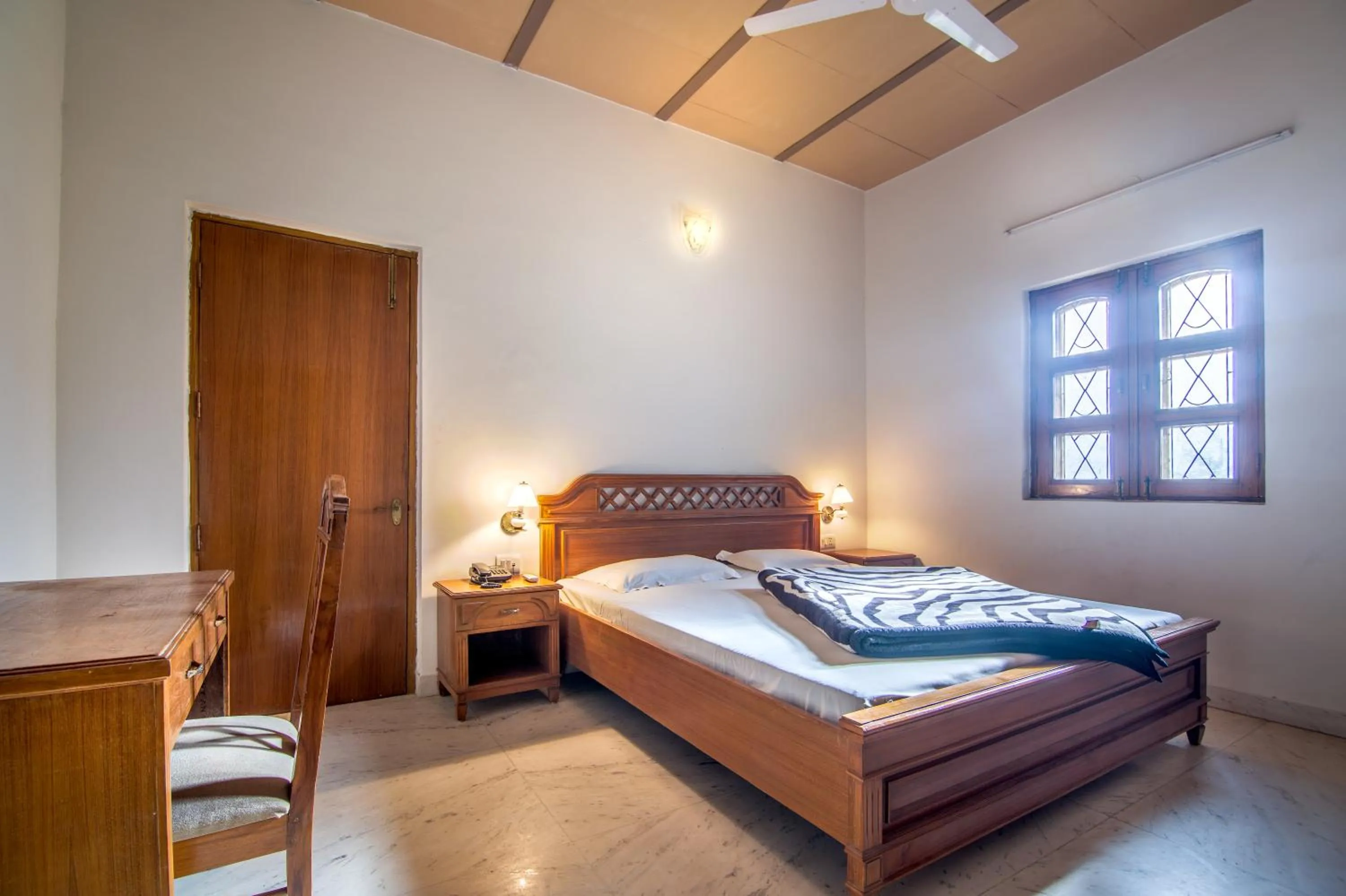 Bed in Hotel Bhakti Dhama