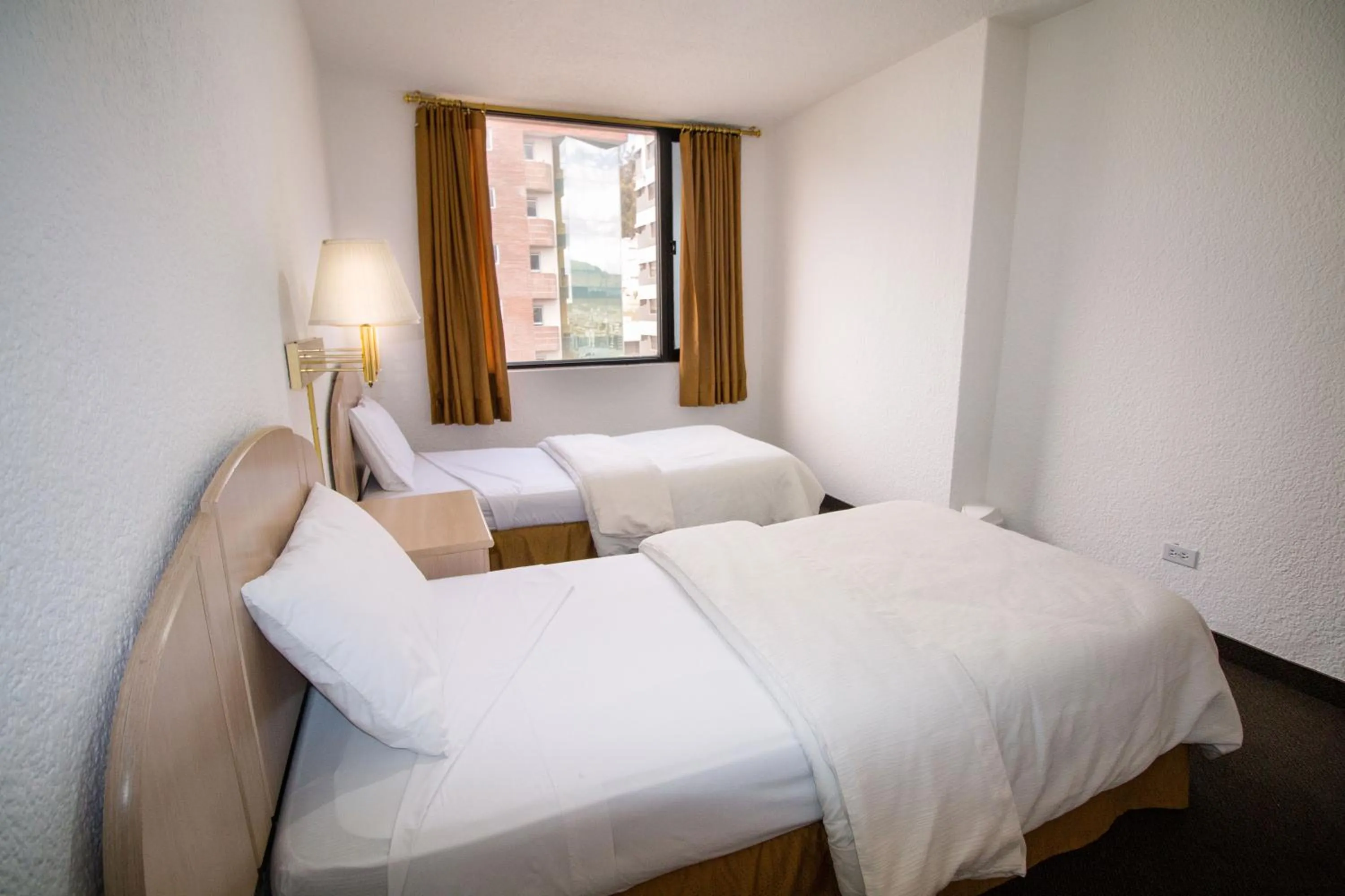 Bed in Stanford Suites Hotel