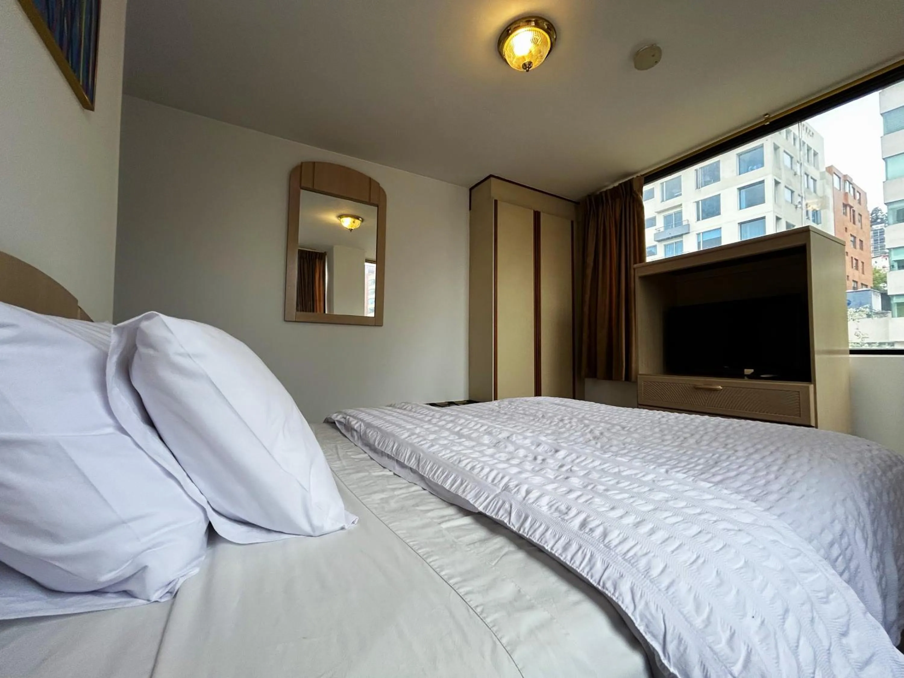 Bed in Stanford Suites Hotel