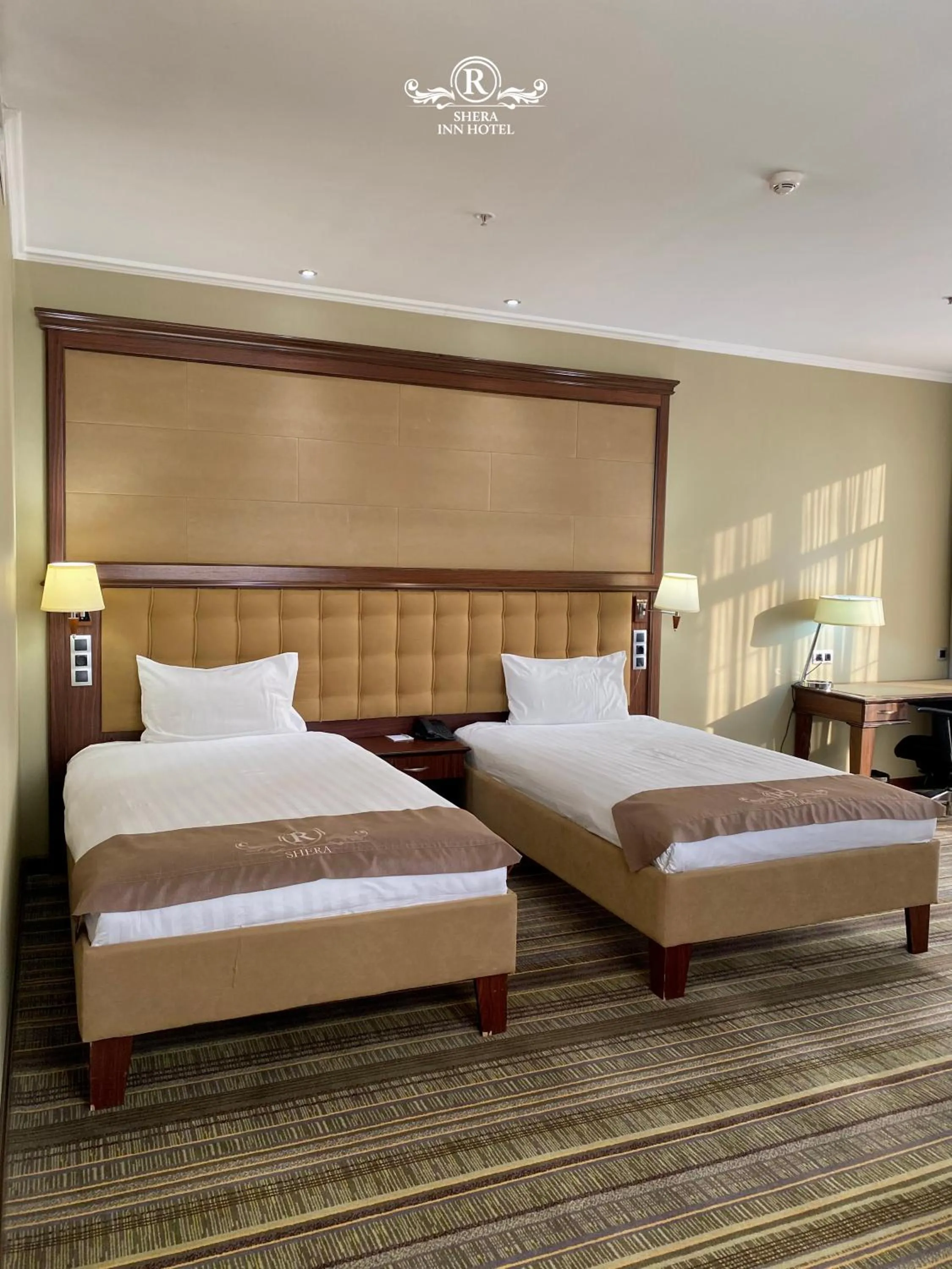 Bed in Shera Inn Hotel