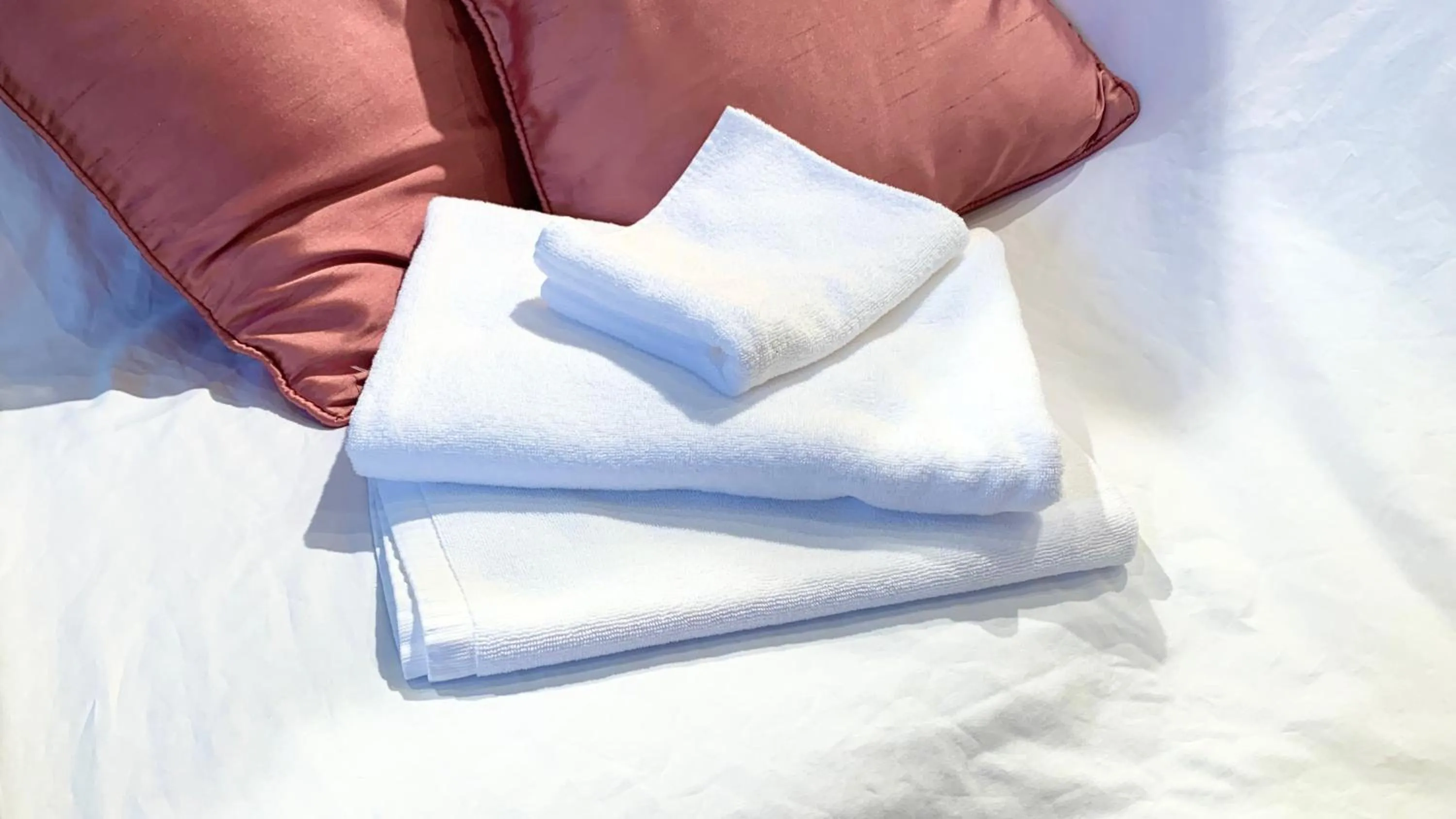 towels, Bed in Smile Hotel Naha City Resort