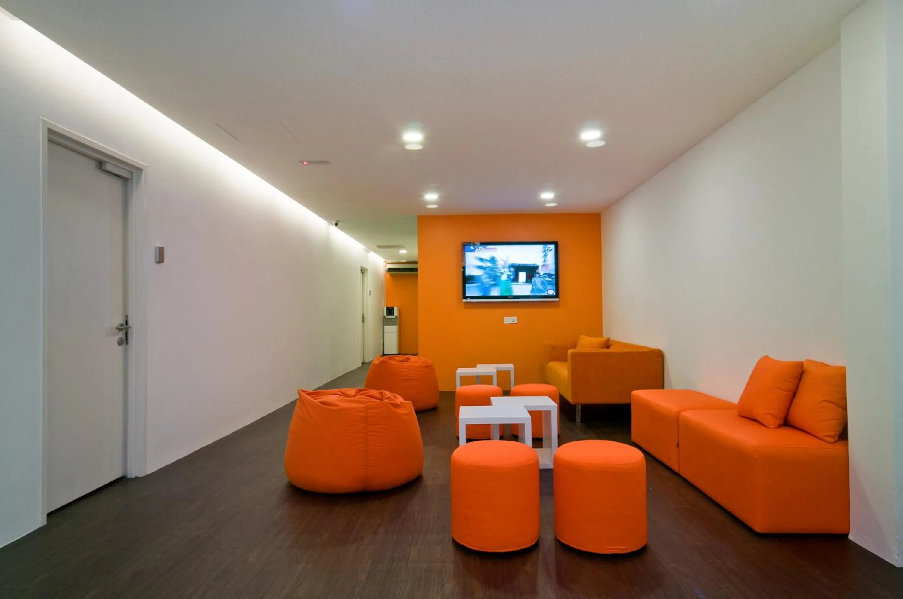 Communal lounge/ TV room in M Qube Hotel