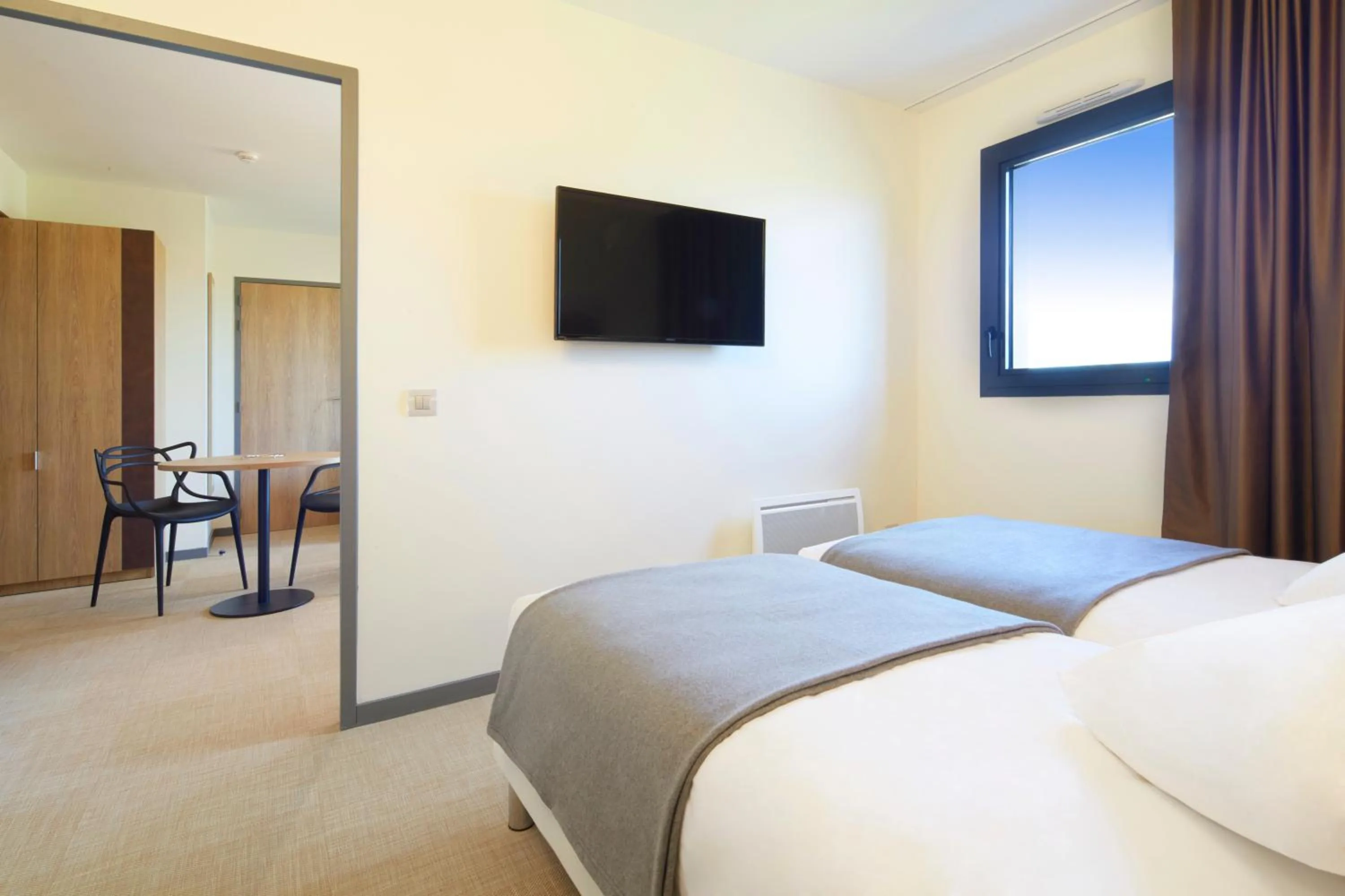 Bed in Kyriad Prestige Residence & Spa Cabourg-Dives-sur-Mer