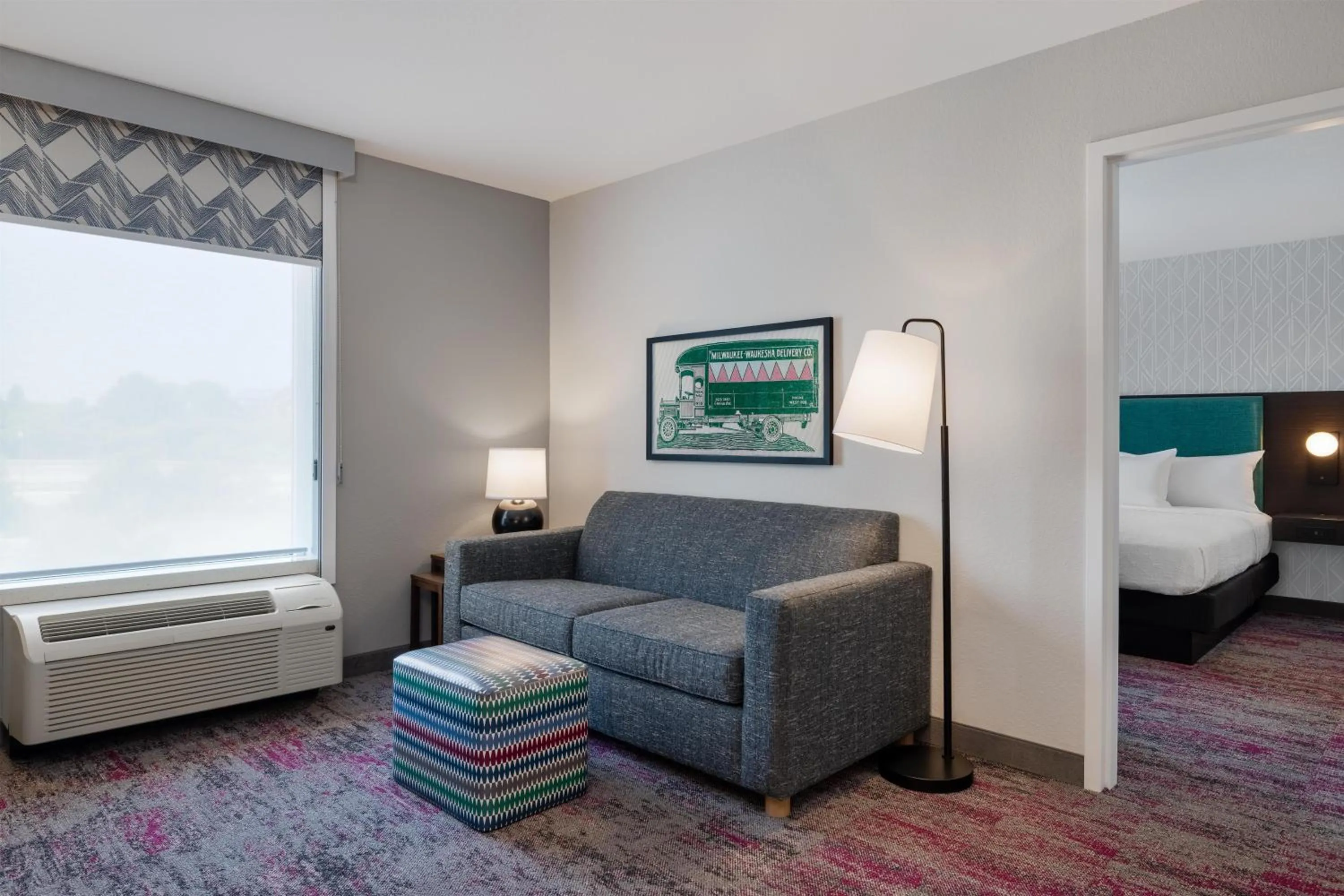 Living room, Bed in Home2 Suites by Hilton Milwaukee Brookfield