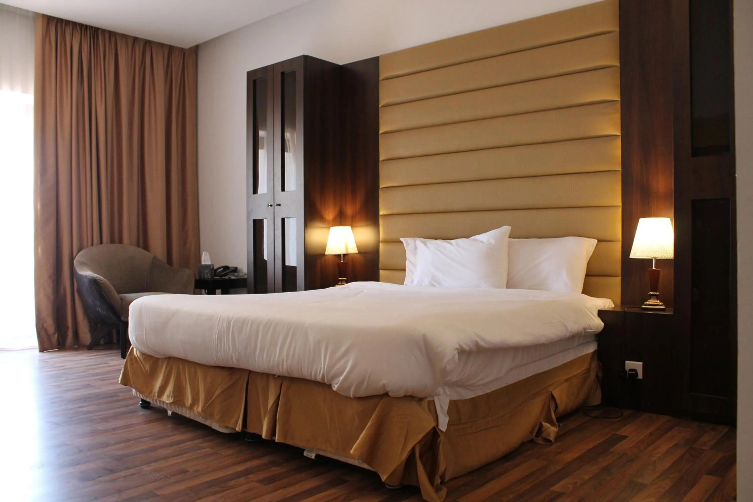 Bed in Golden Tulip Al Khobar Suites