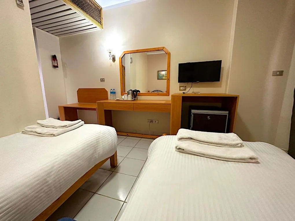 Bed in Gaddis Hotel, Suites and Apartments