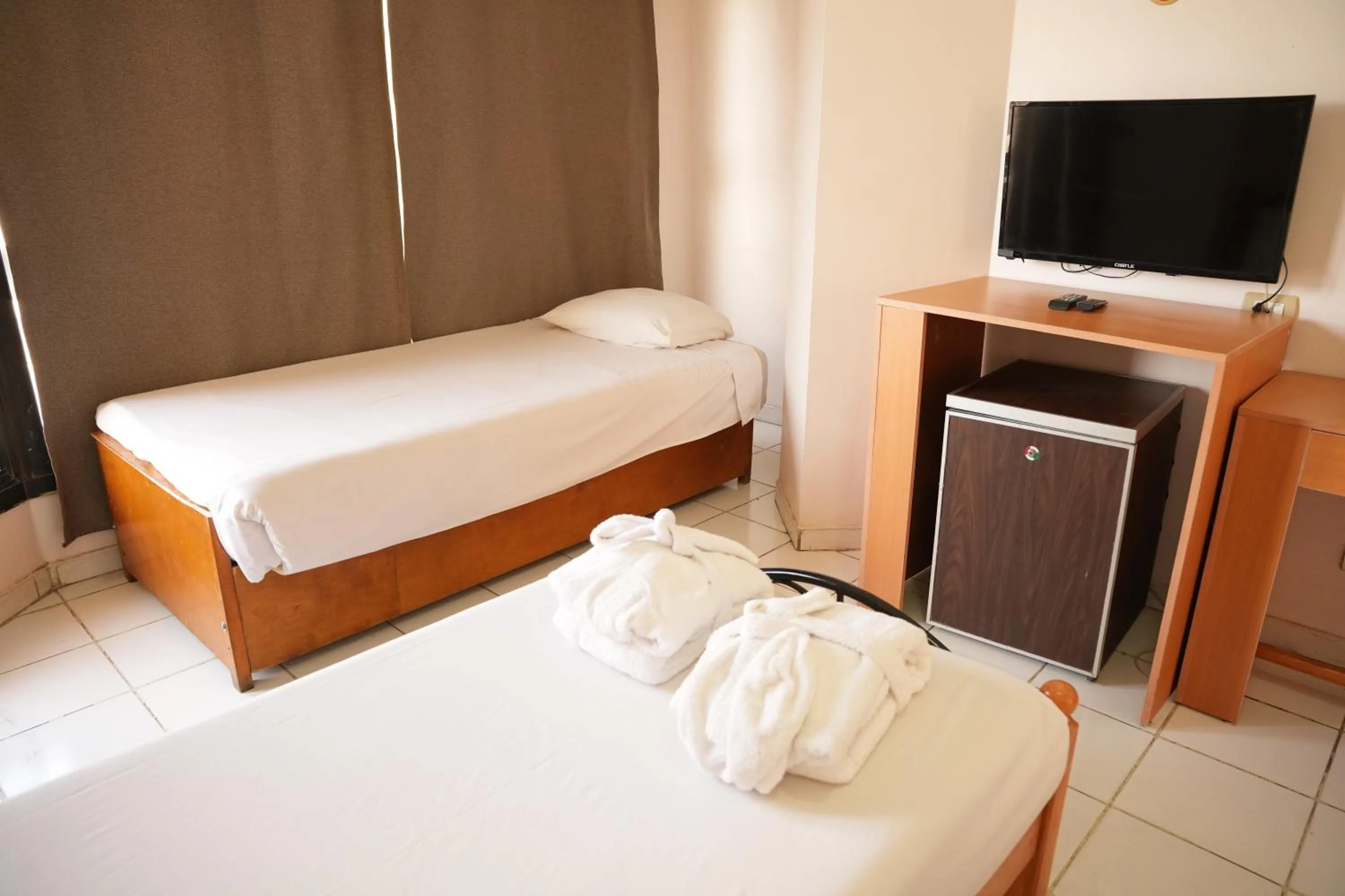 Bed in Gaddis Hotel, Suites and Apartments