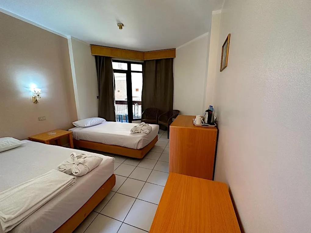 Bed in Gaddis Hotel, Suites and Apartments