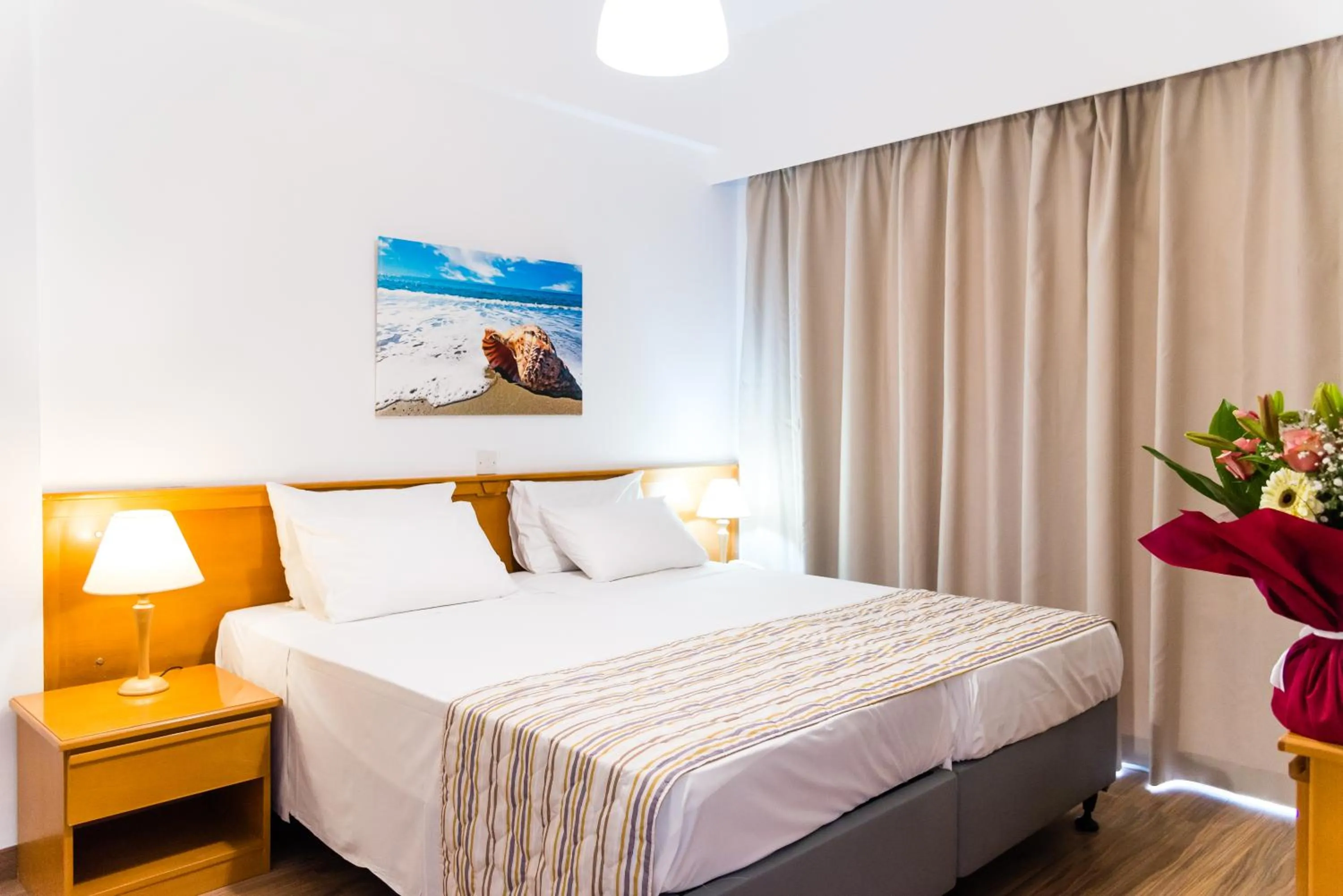 Bed in Helios Bay Hotel and Suites