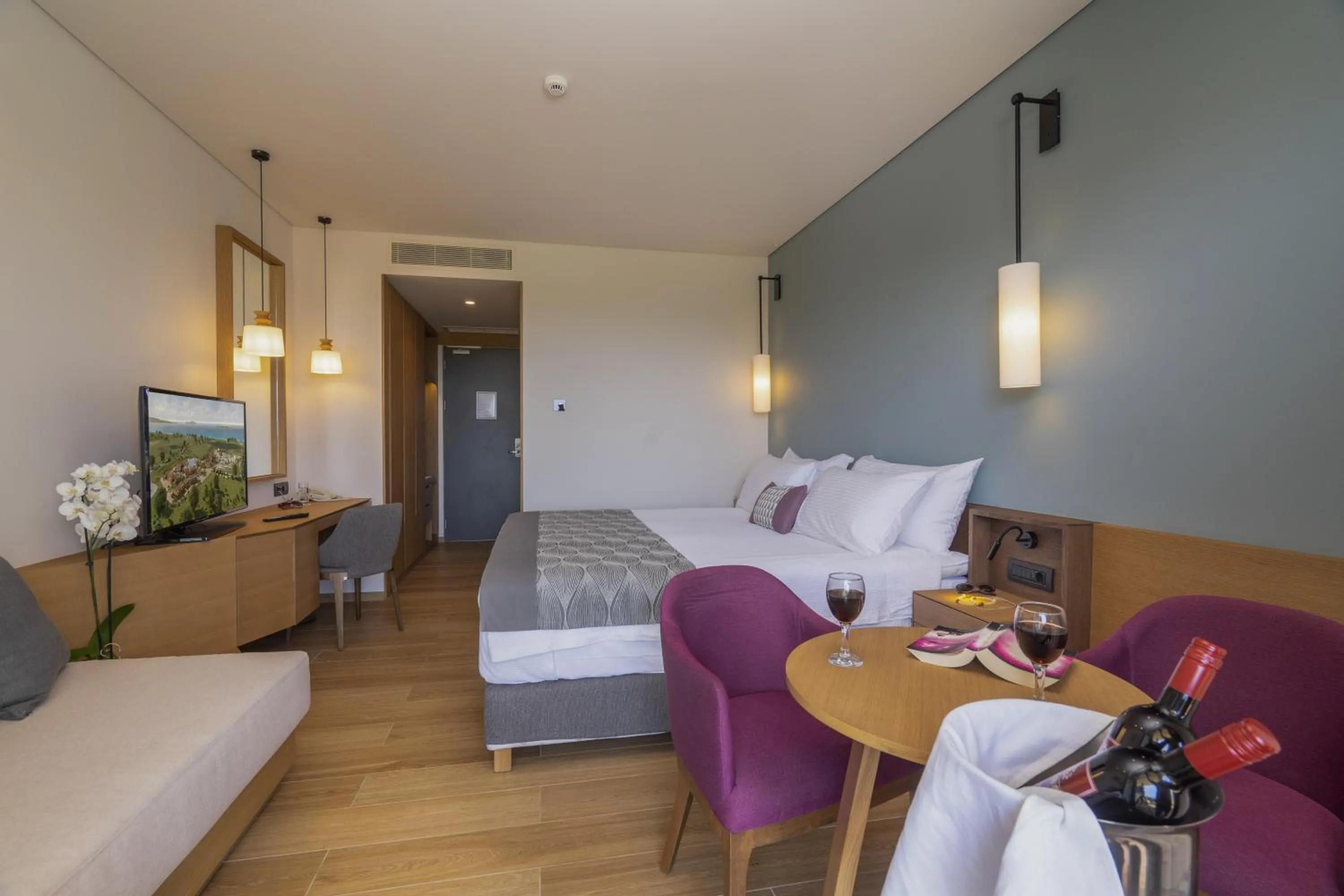 Seating area, Bed in Apollonion Asterias Resort and Spa