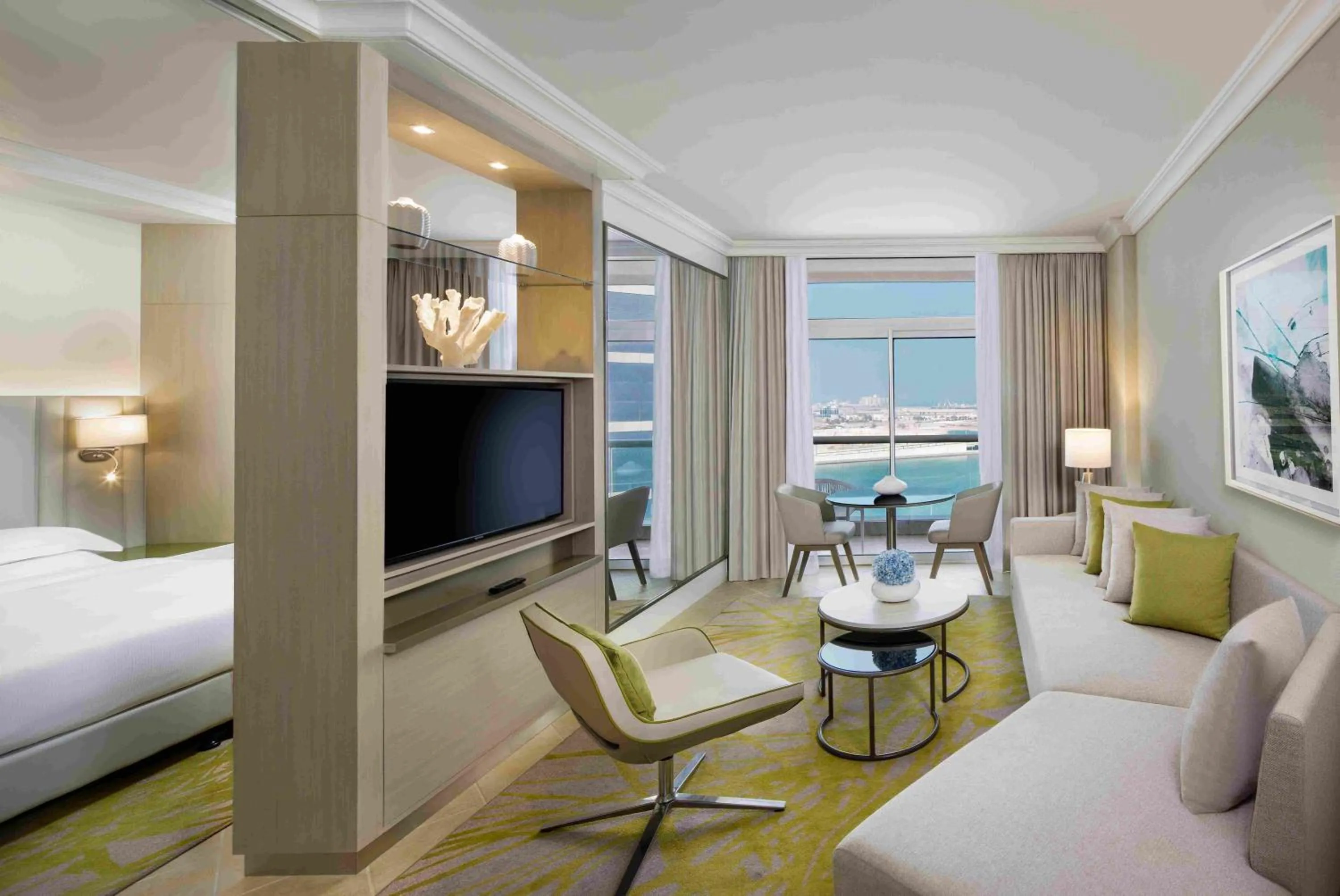 Living room, Bed in Beach Rotana – All Suites