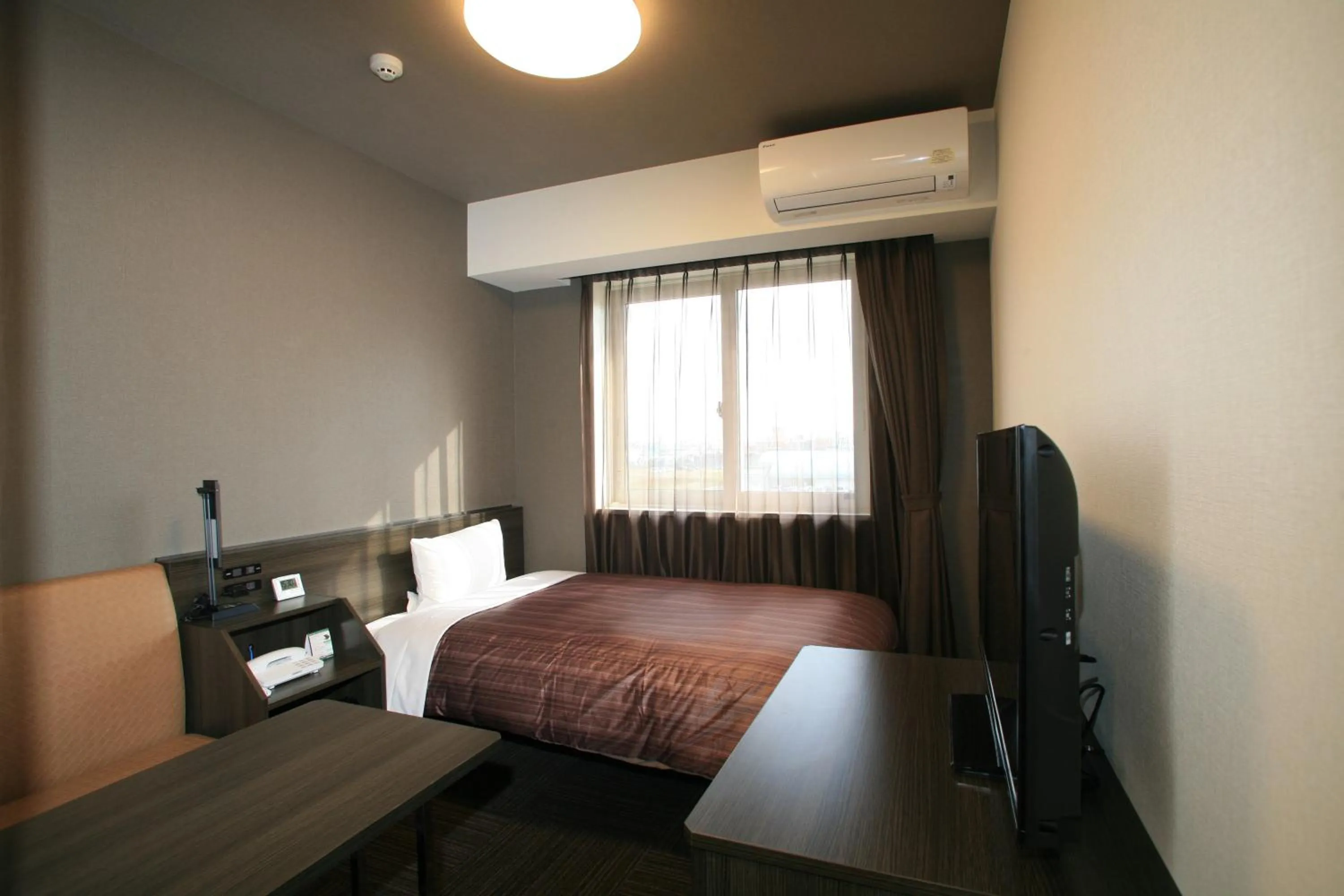 Bed in Hotel Route-Inn Natori Iwanuma Inter -Sendai Kuko-