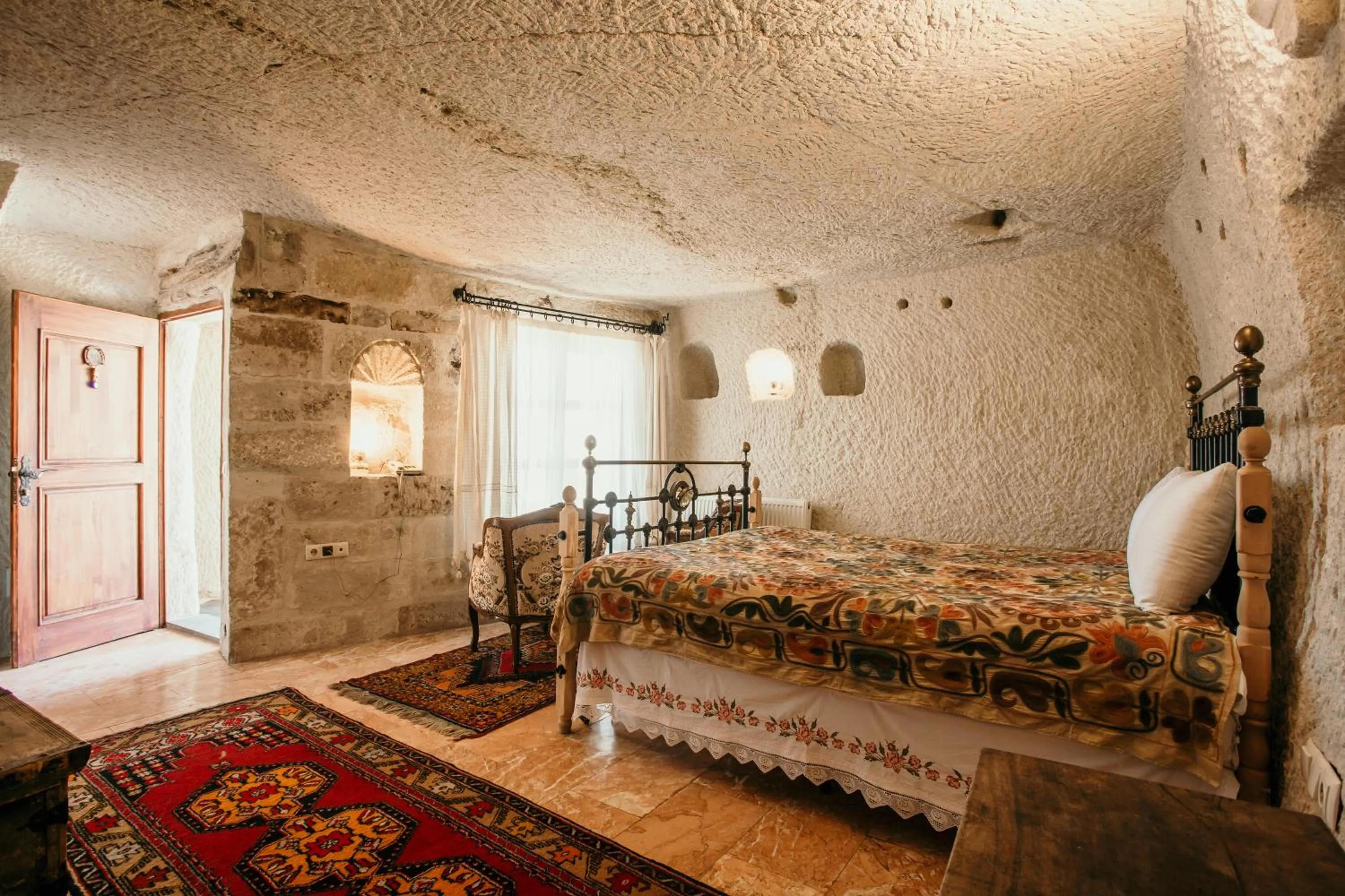 Bed in Village Cave House Hotel