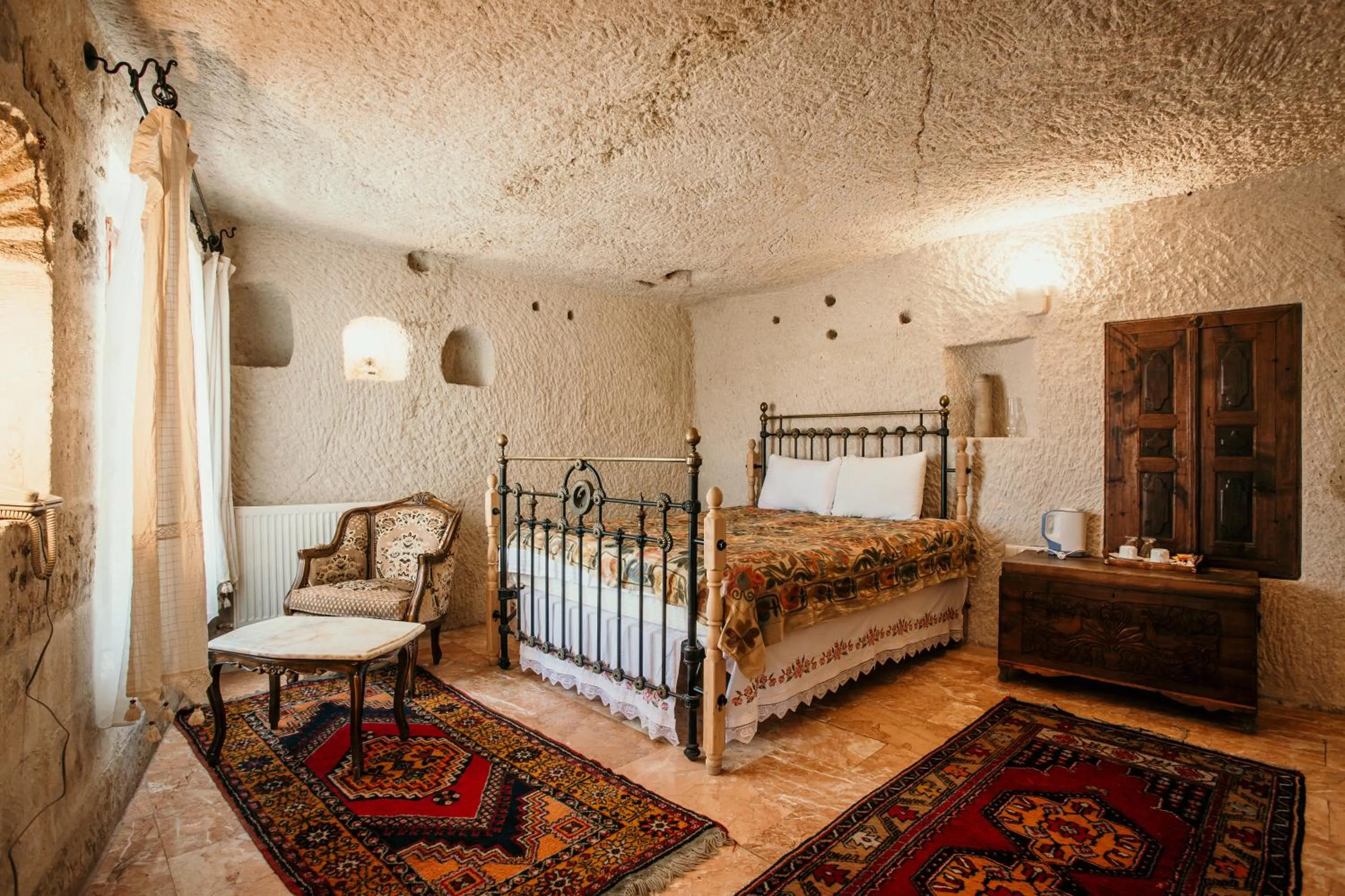 Bed in Village Cave House Hotel