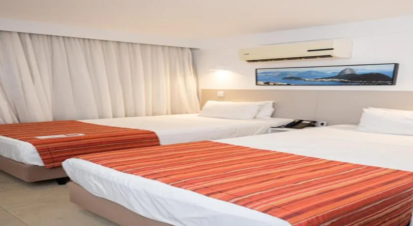 Bed in Ramada by Wyndham Macae Hotel & Suites