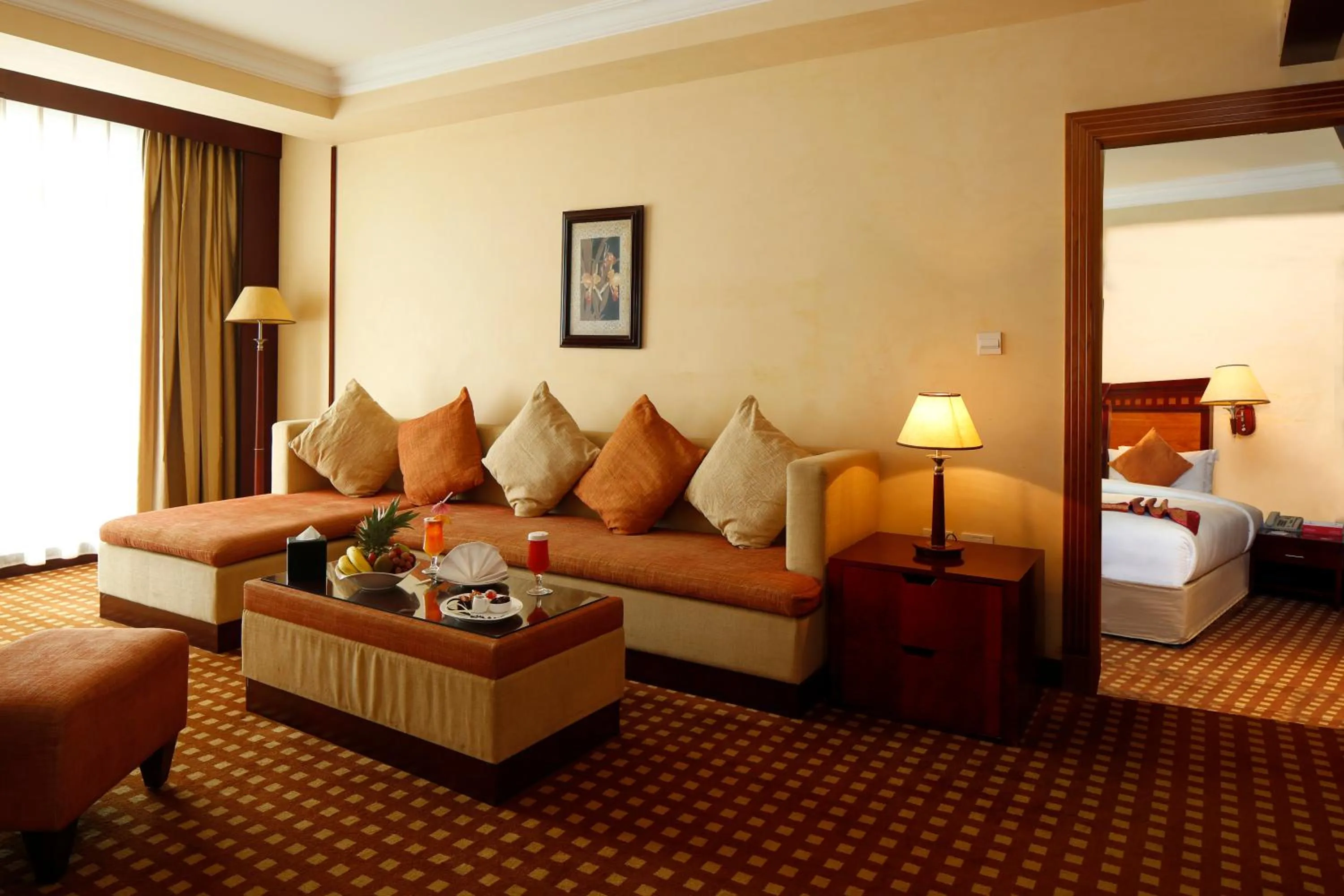 Living room, Bed in Ramada Riyadh Hotel