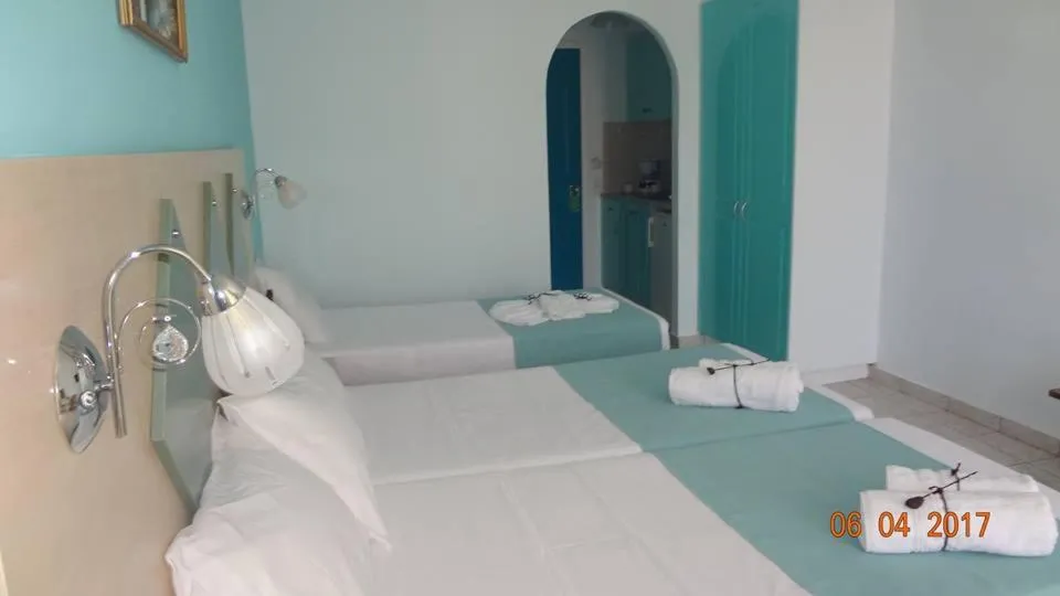 Bed in Vossos Hotel Apartments