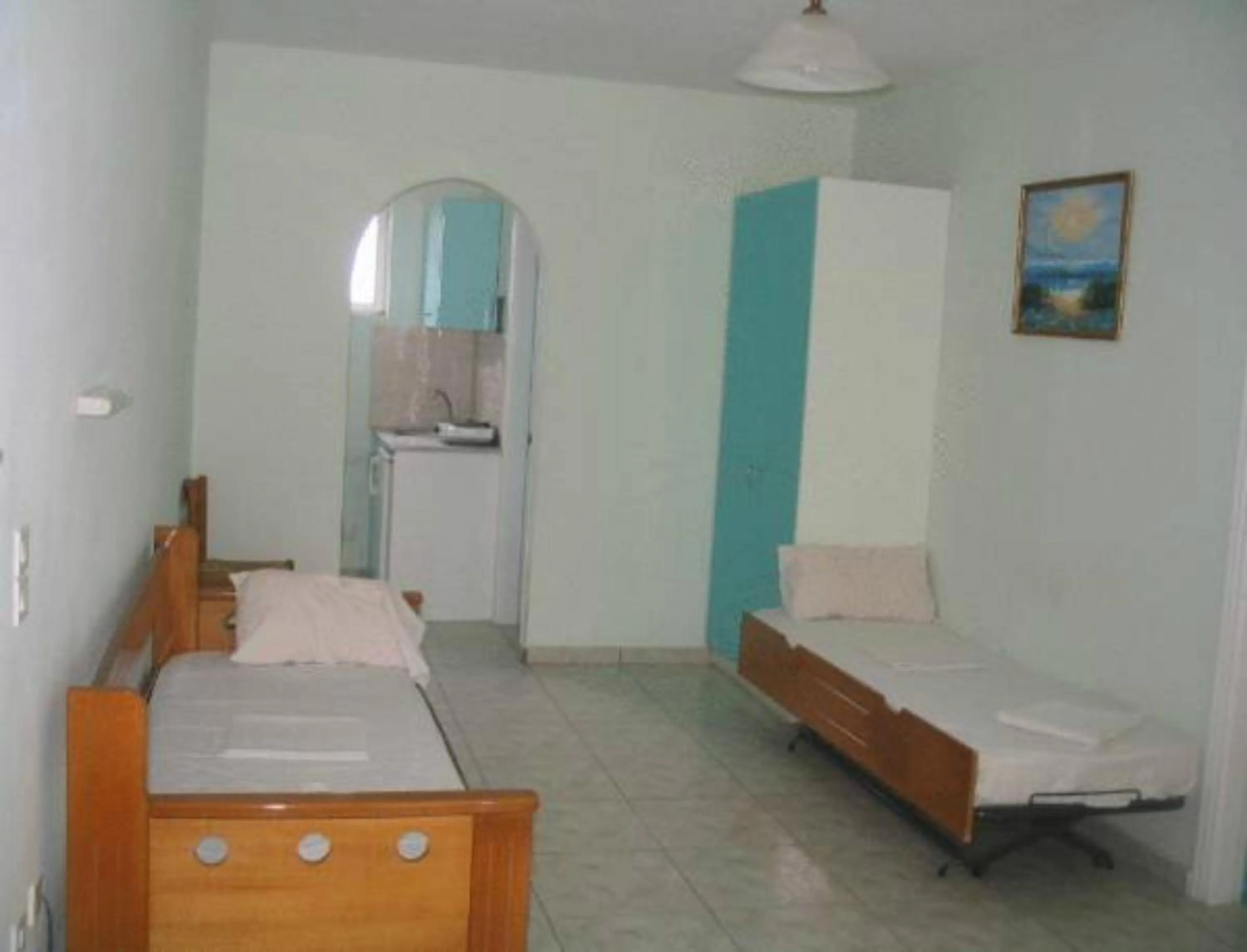 Bed in Vossos Hotel Apartments