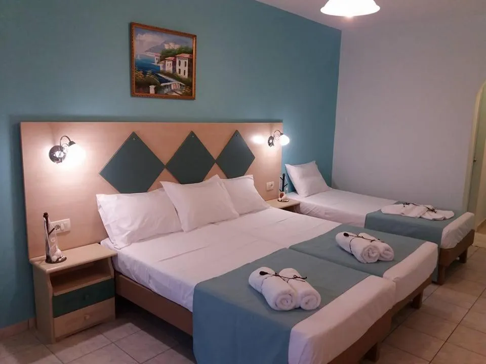 Bed in Vossos Hotel Apartments