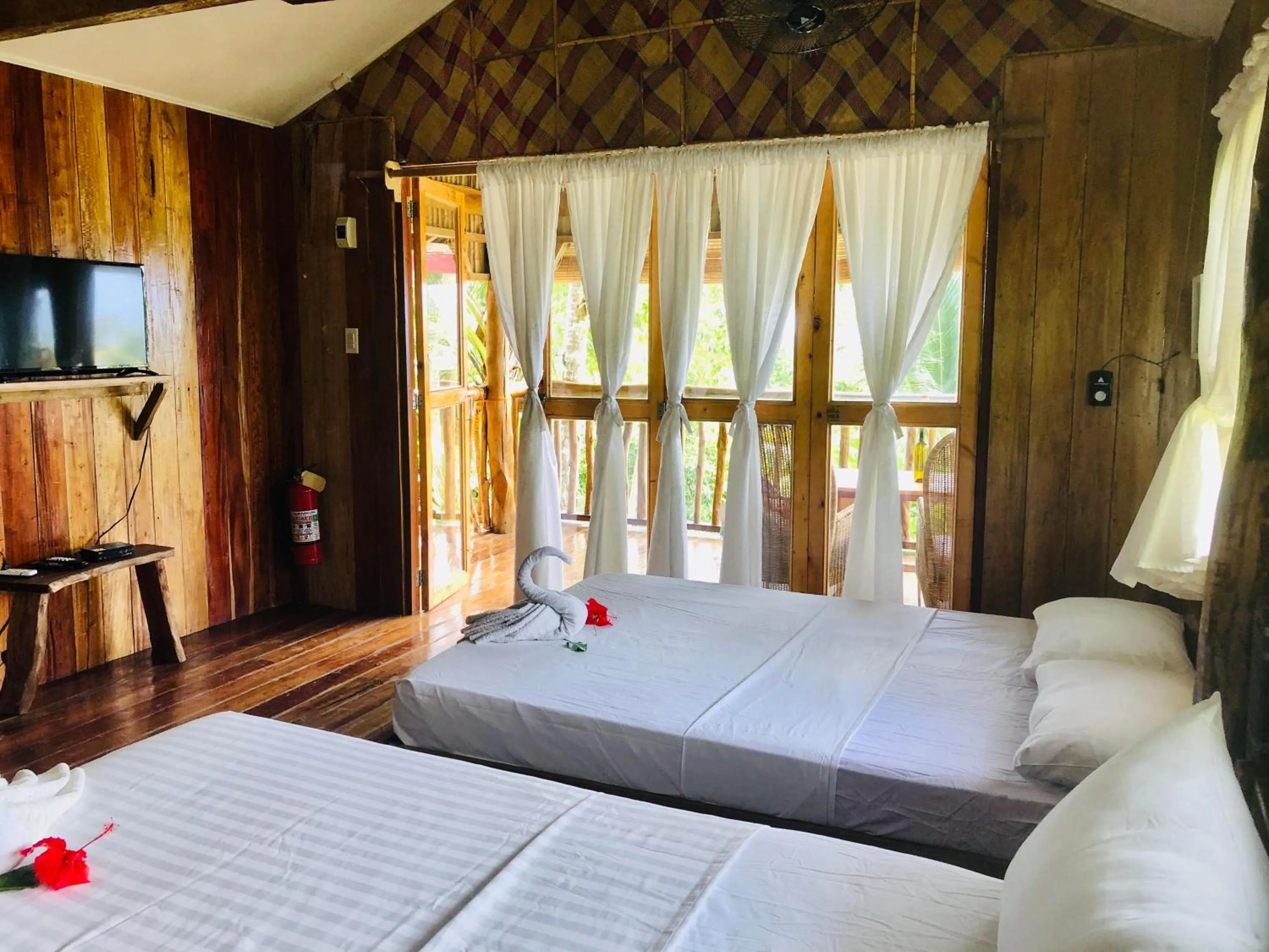 Photo of the whole room, Bed in White Beach Front and Cottages