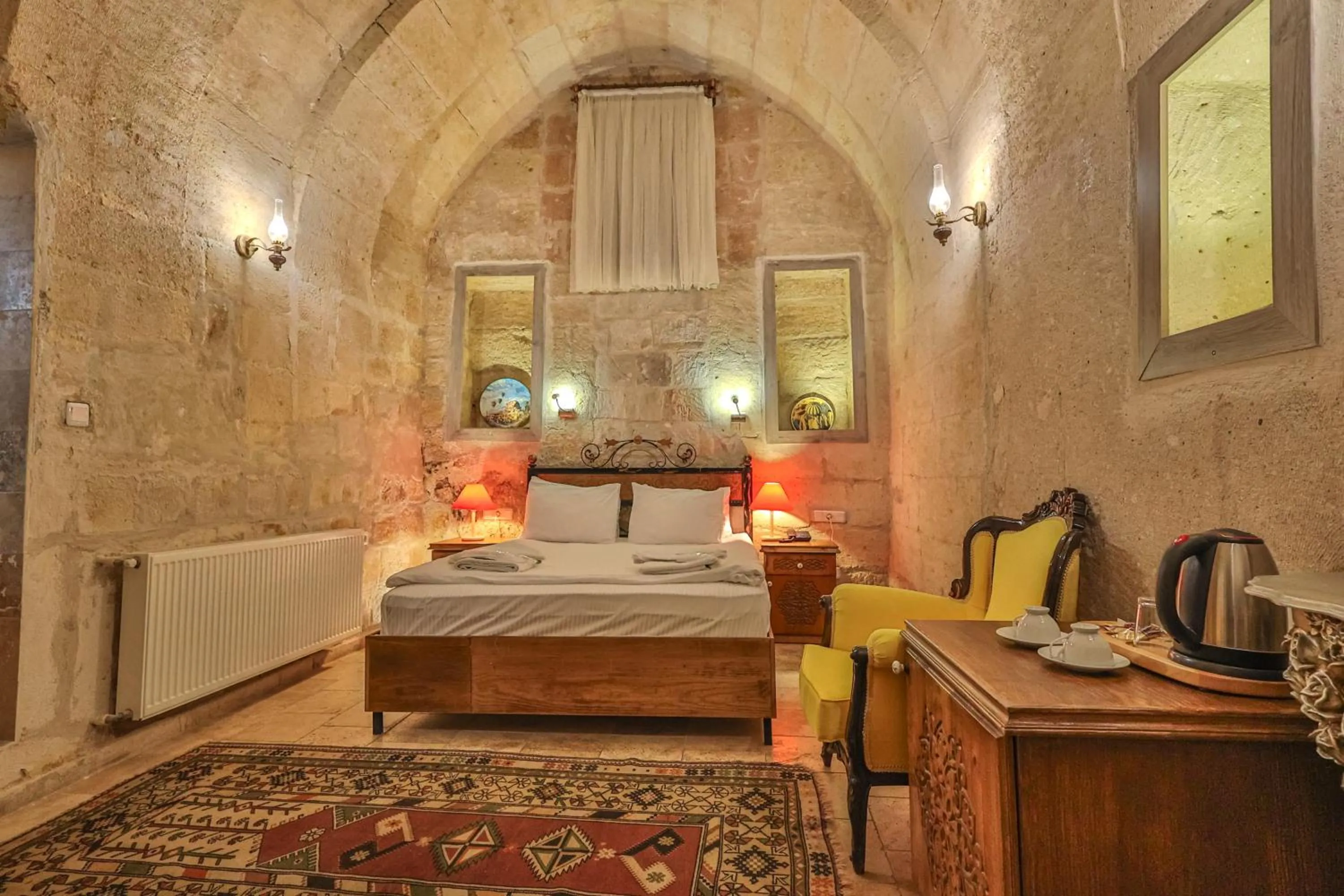 Living room, Bed in Bedrock Cave Hotel
