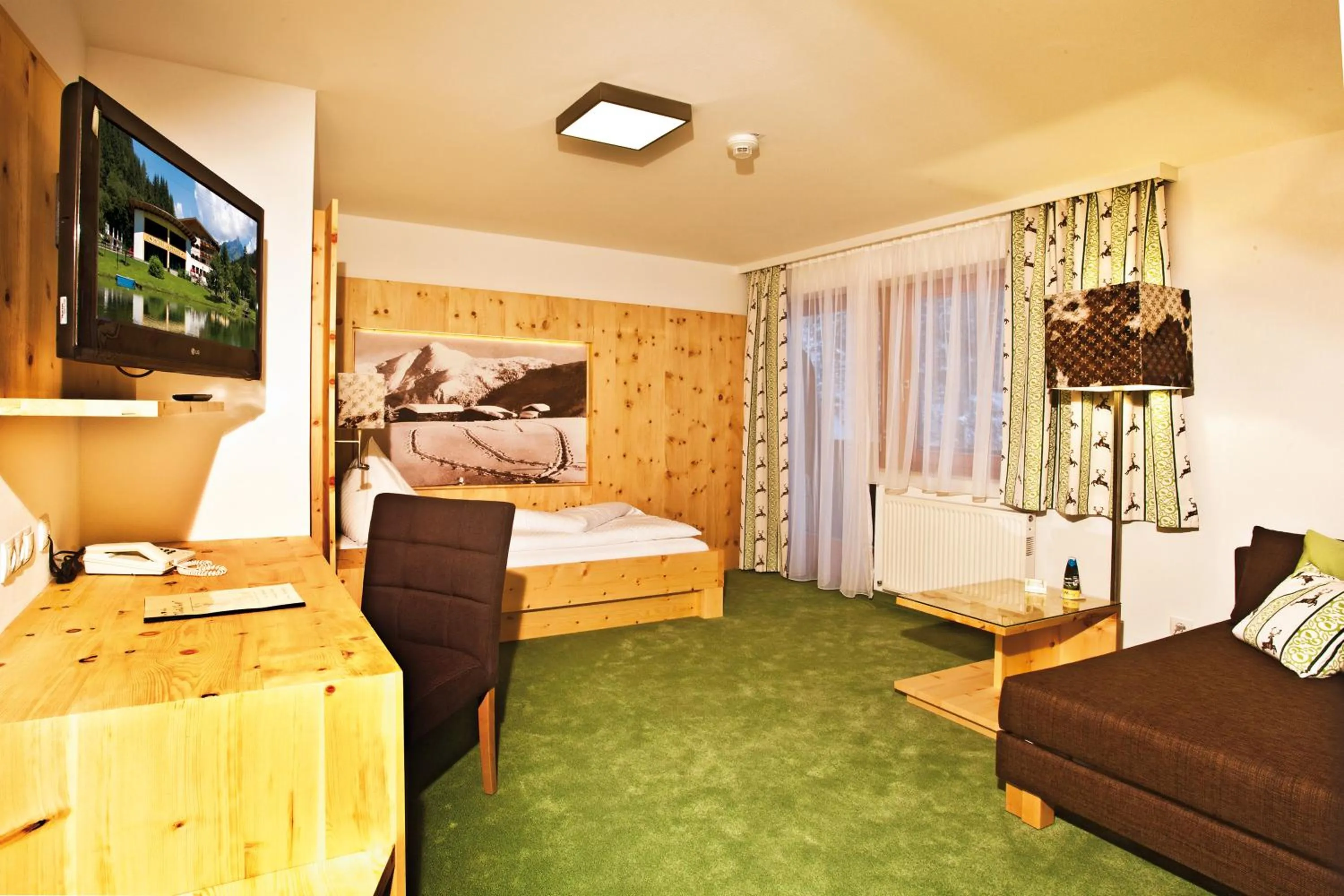 Photo of the whole room, Bed in Landhotel Alpenhof Filzmoos