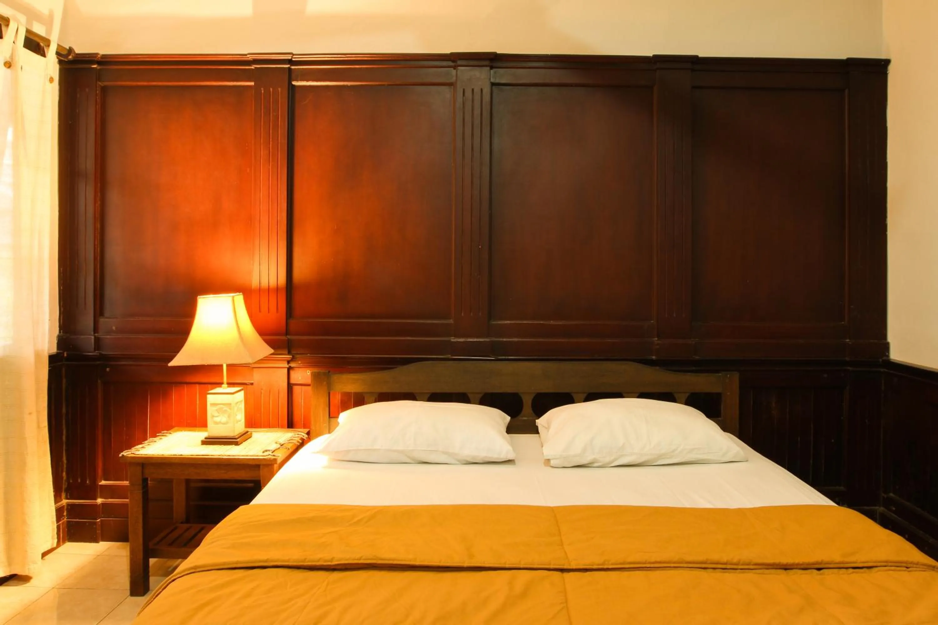 Bed in Sari Indah Cottages