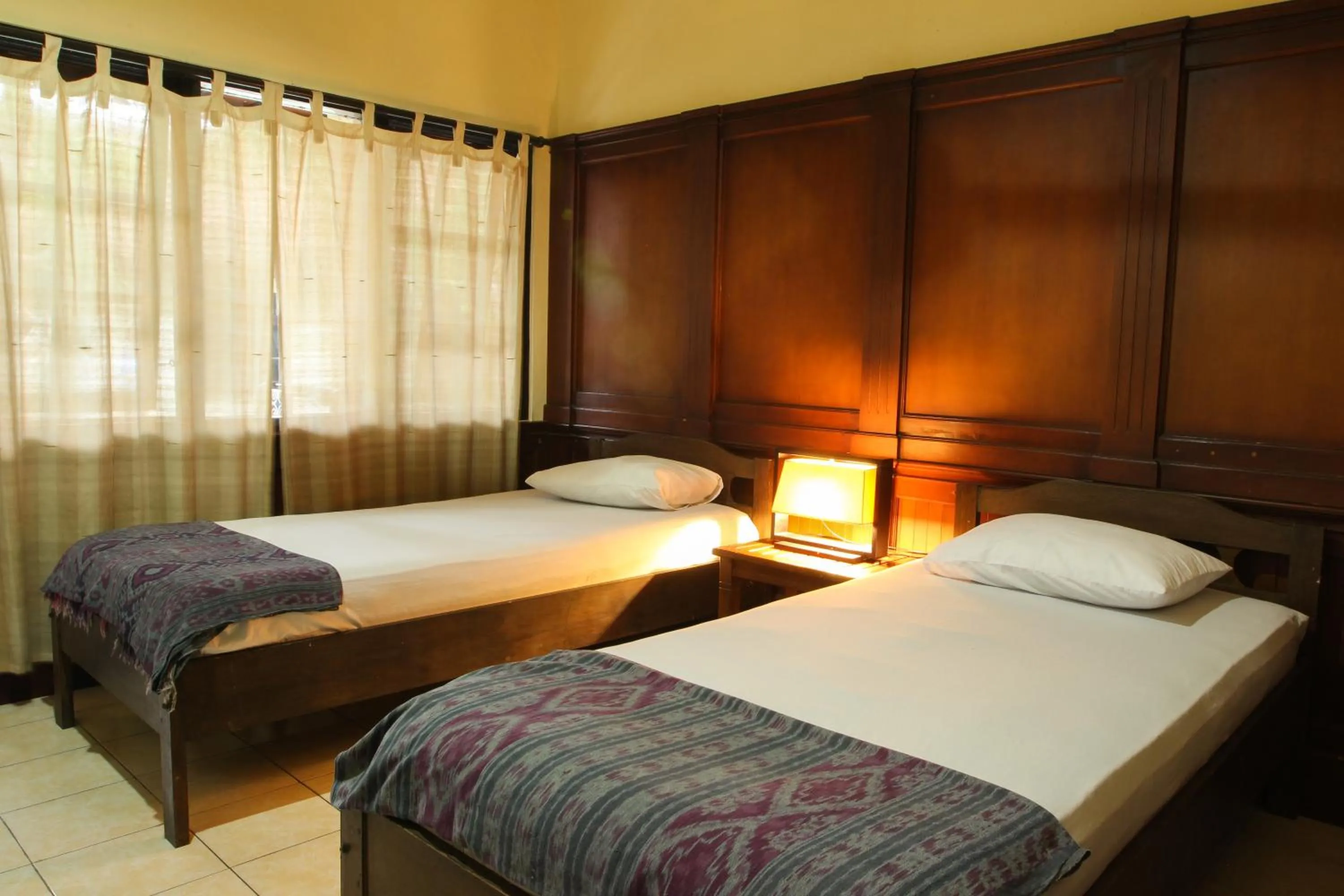 Bed in Sari Indah Cottages