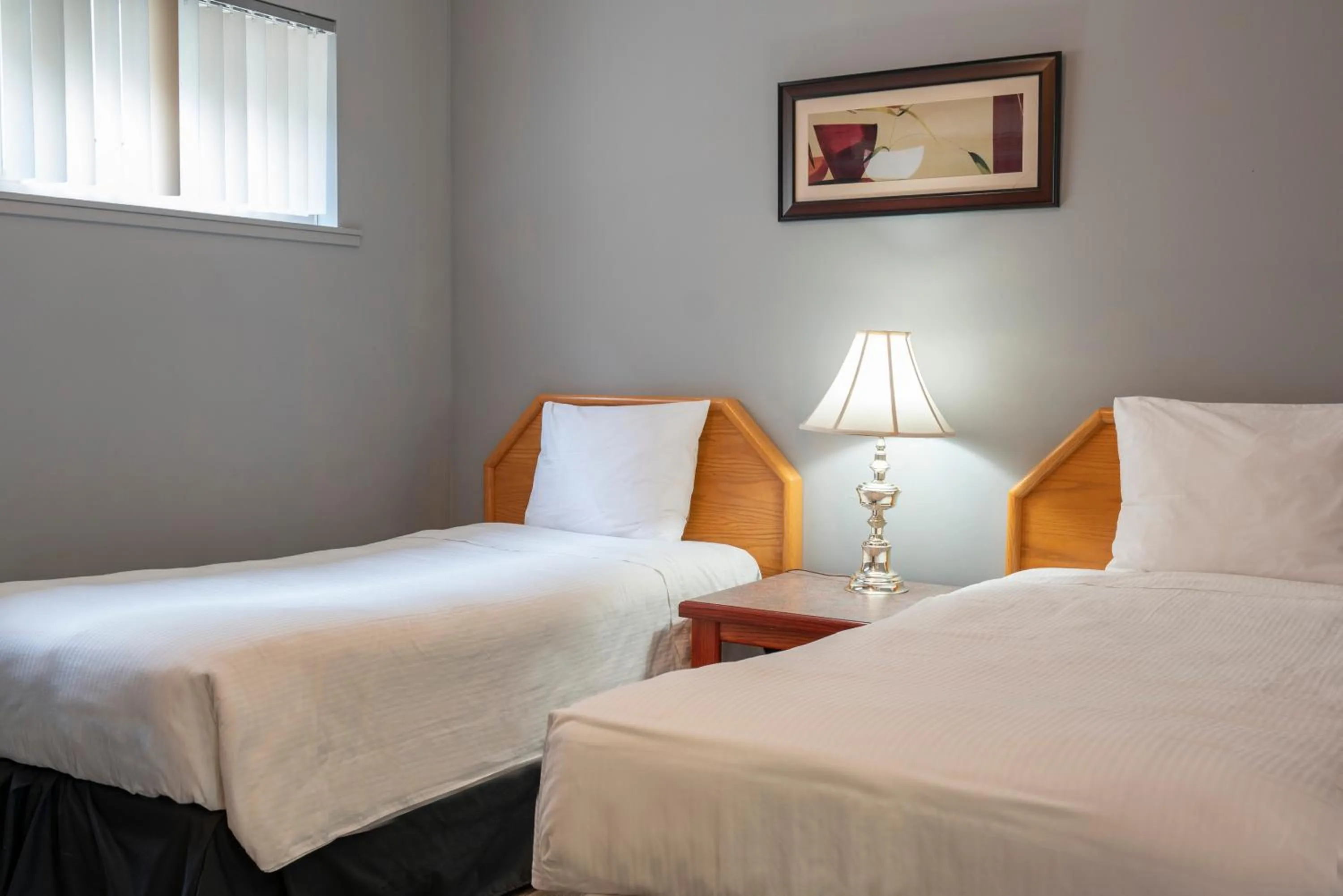 Bed in Tiki Shores Inn & Suites