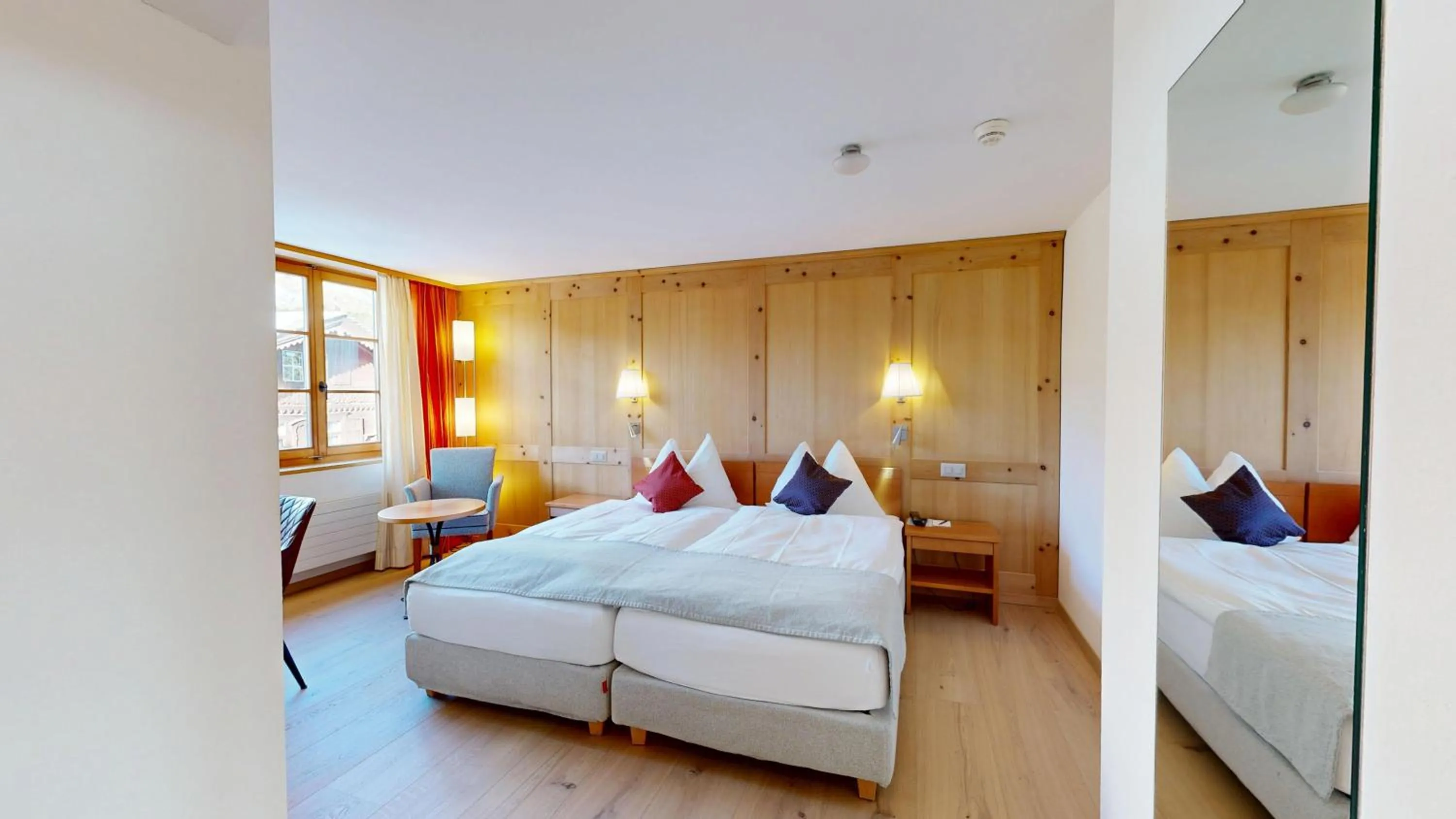 Bed in Schweizerhaus Swiss Quality Hotel