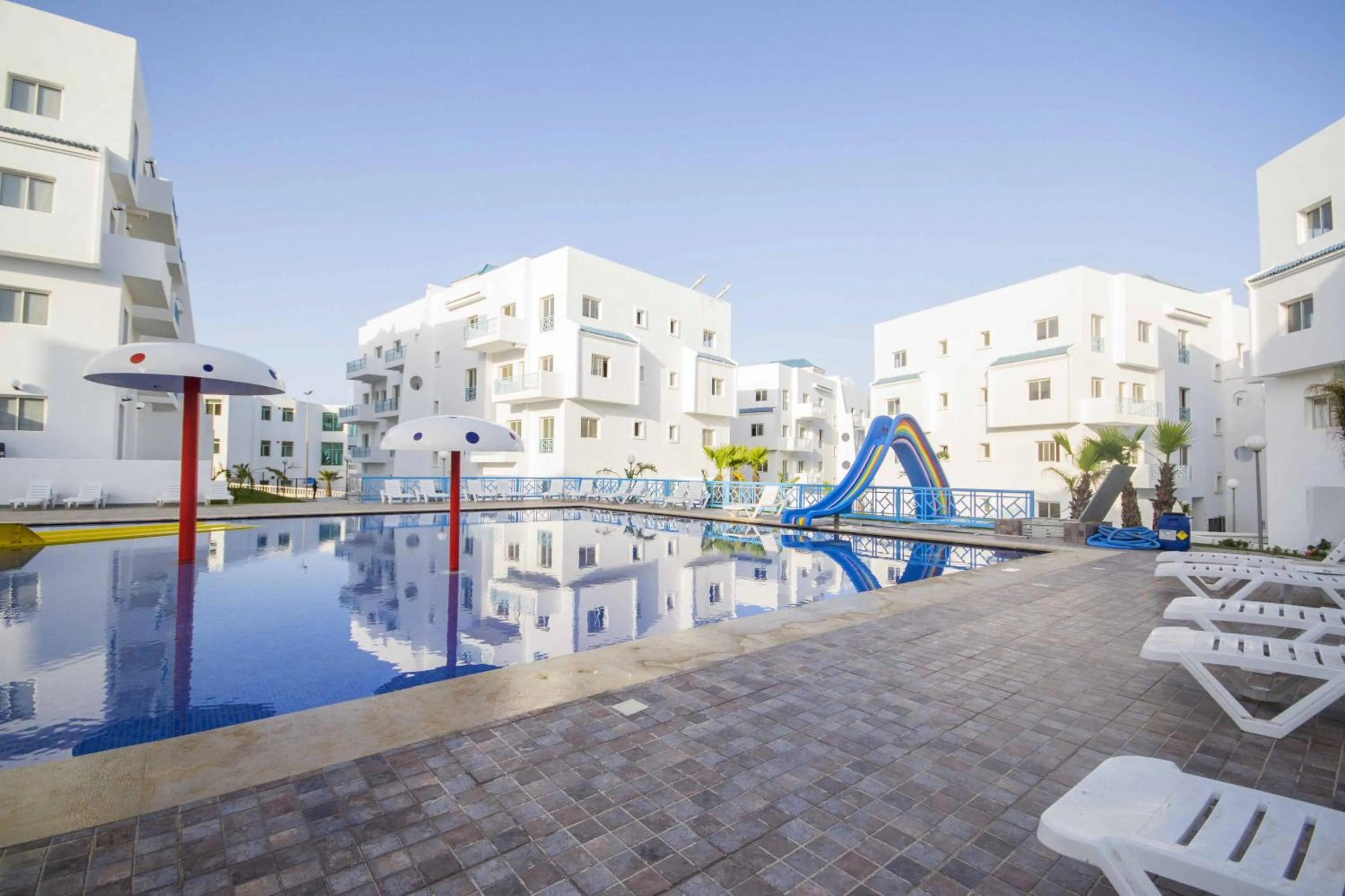 Swimming pool in L'escale Appart-hôtel By 7AV HOTELS