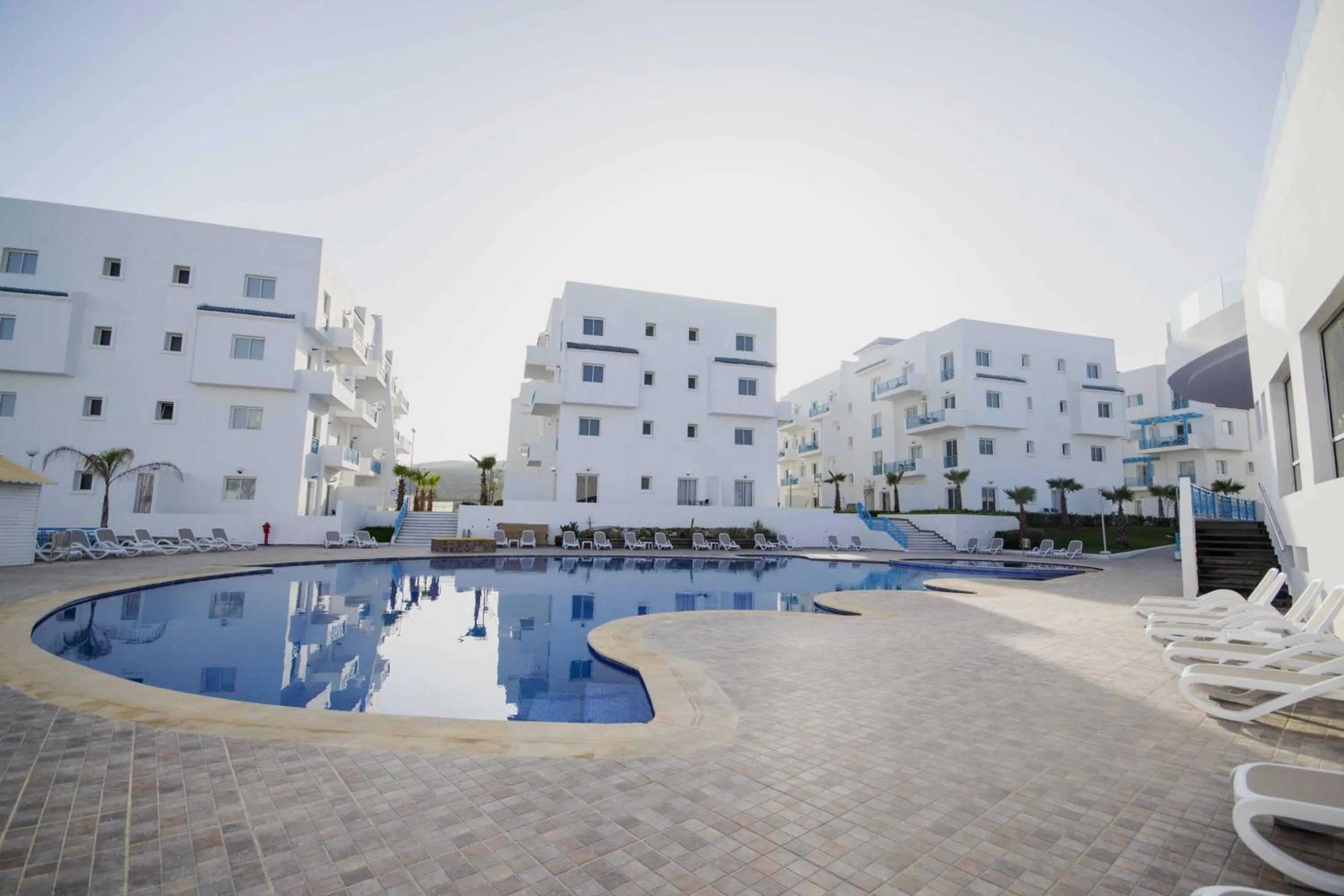 Swimming pool in L'escale Appart-hôtel By 7AV HOTELS