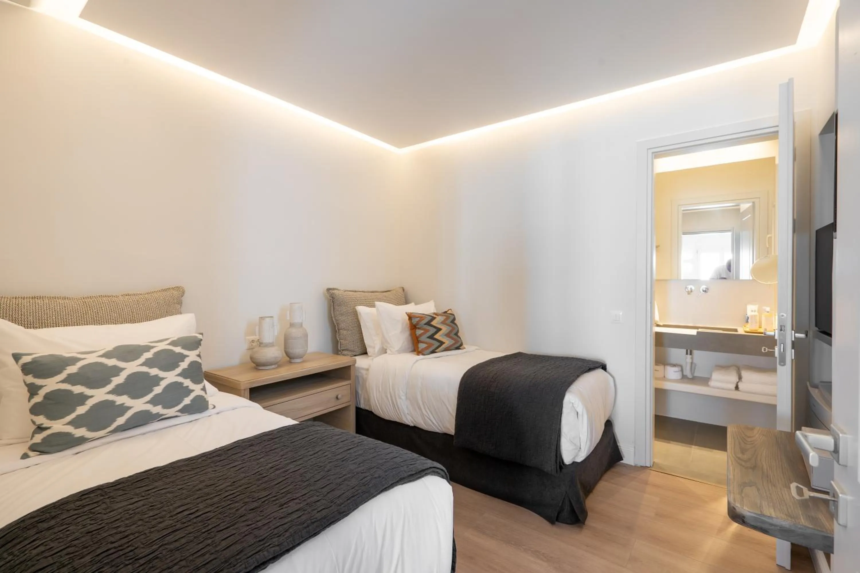 Bed in NĒRO Suites by NOMÉE Hospitality Group