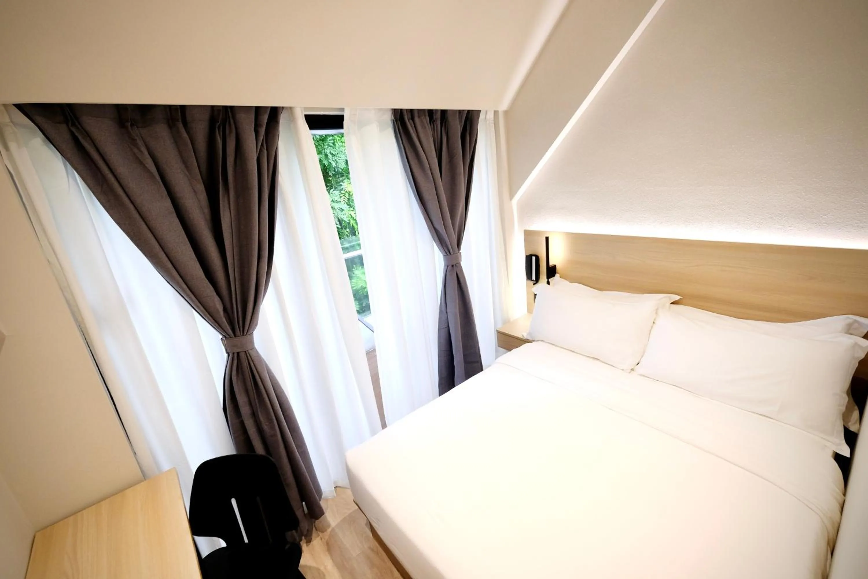 Bed in Rest Bugis Hotel