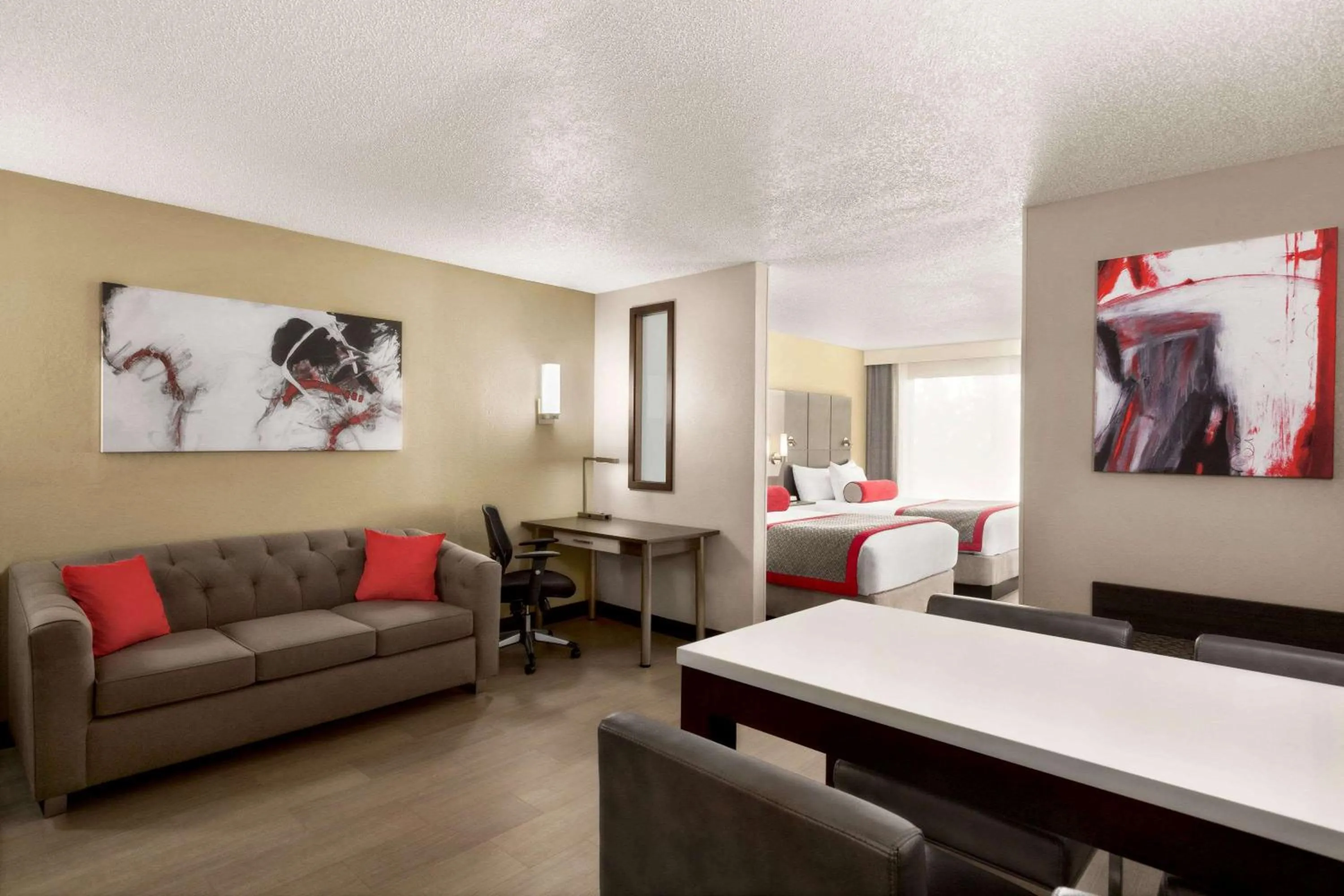 Photo of the whole room, Bed in Ramada by Wyndham Suites Orlando Airport- Free Airport Shuttle