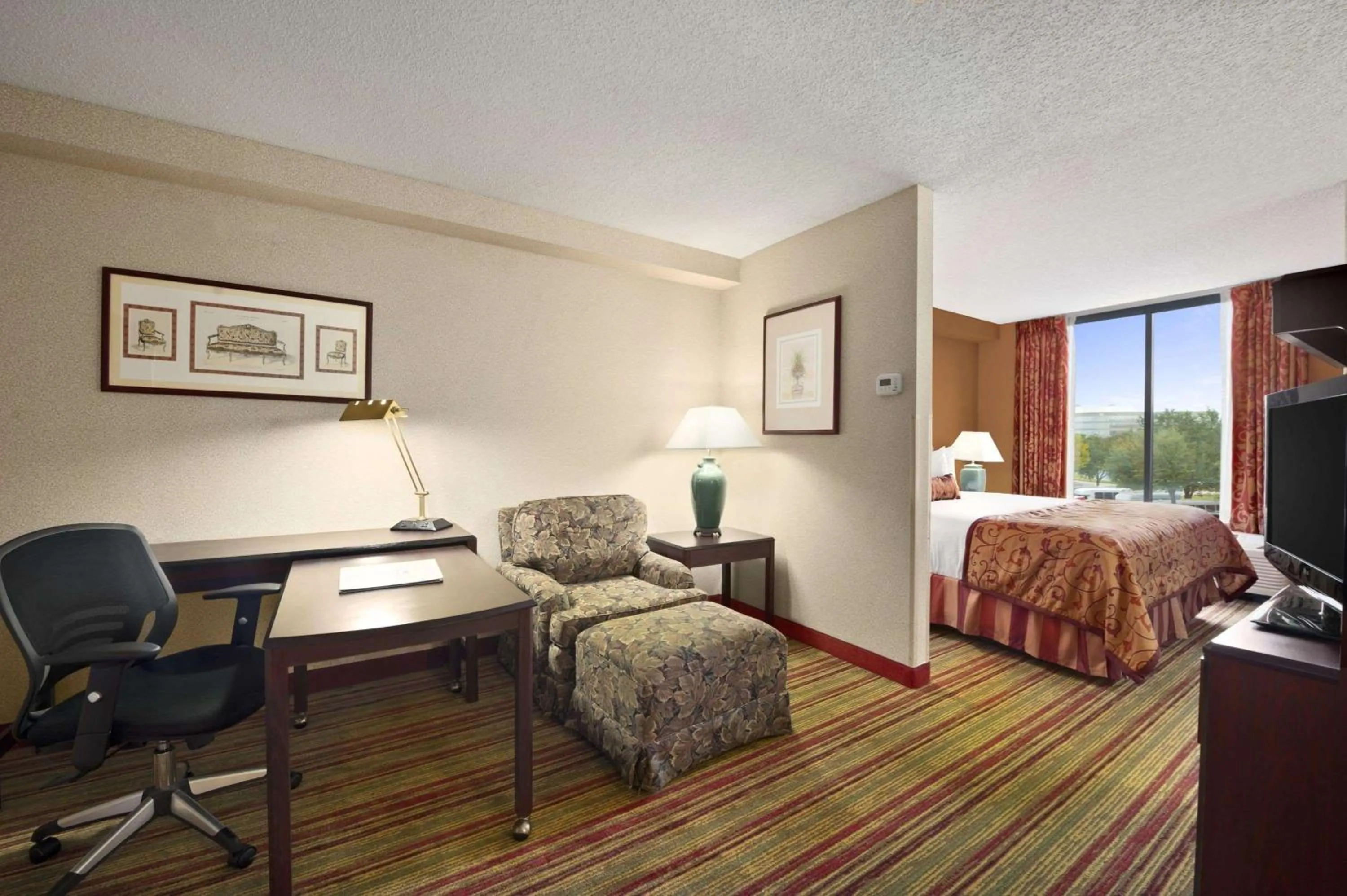 Photo of the whole room, Bed in Ramada by Wyndham Suites Orlando Airport- Free Airport Shuttle