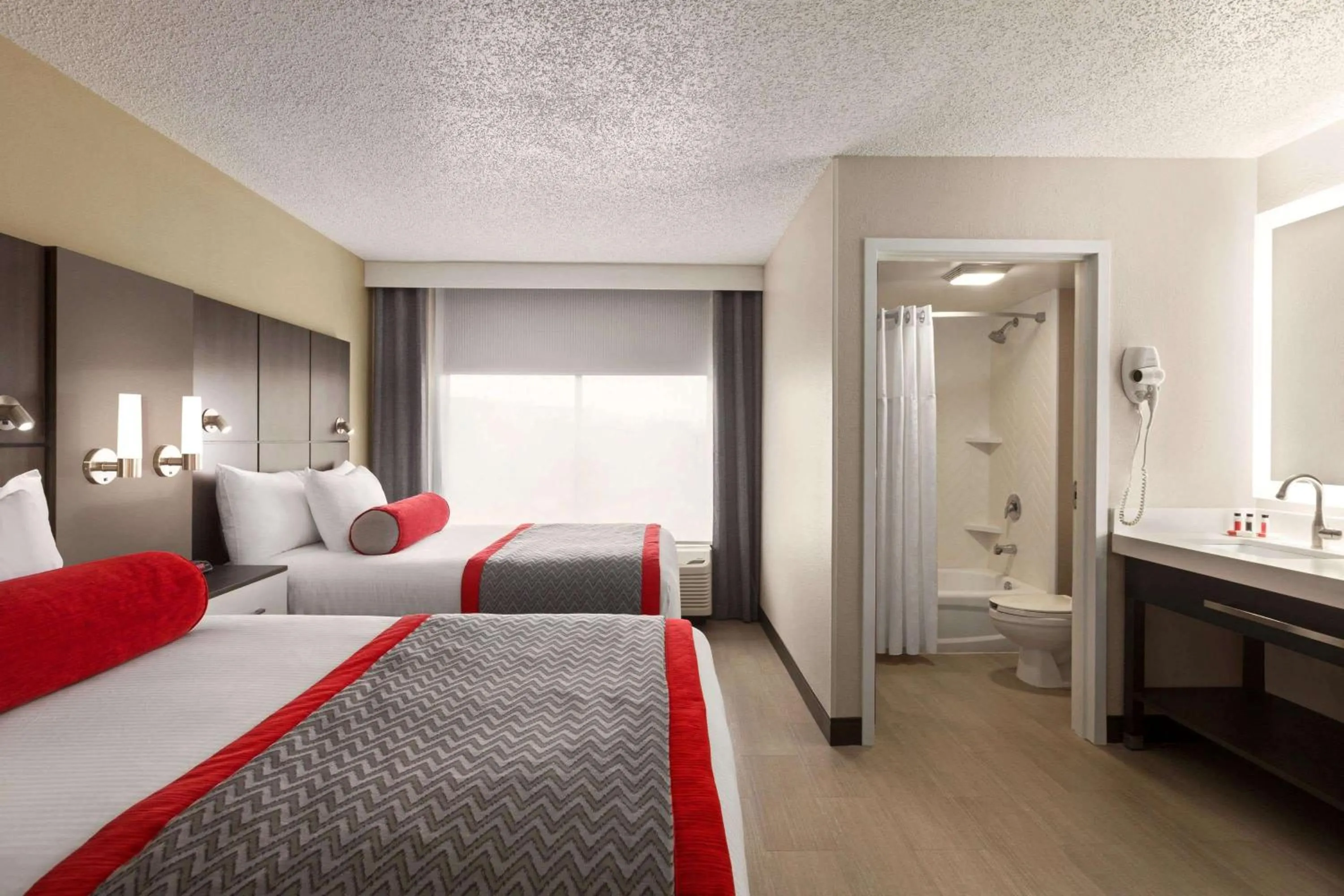 Photo of the whole room, Bed in Ramada by Wyndham Suites Orlando Airport- Free Airport Shuttle