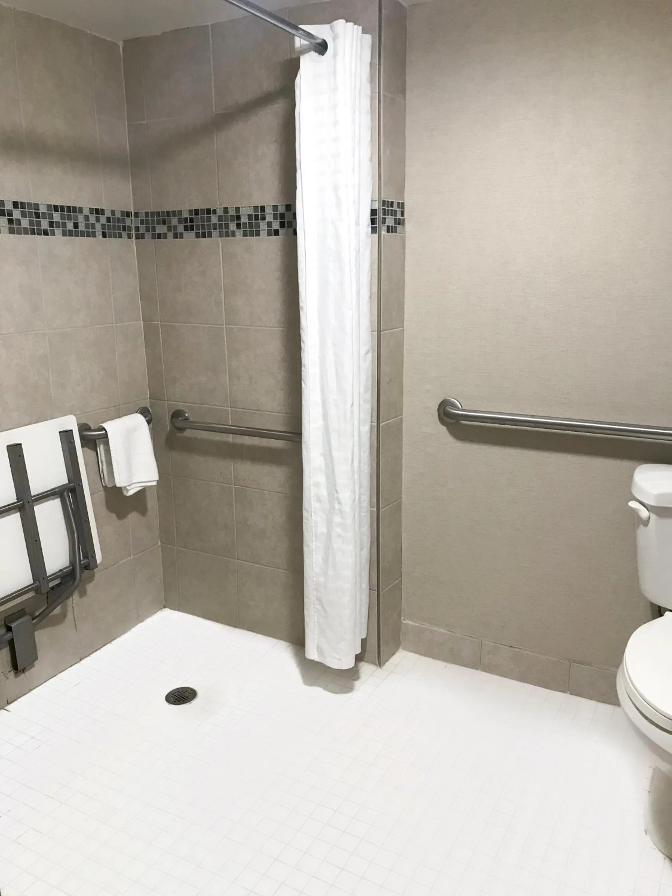 Bathroom in Ramada by Wyndham Suites Orlando Airport- Free Airport Shuttle
