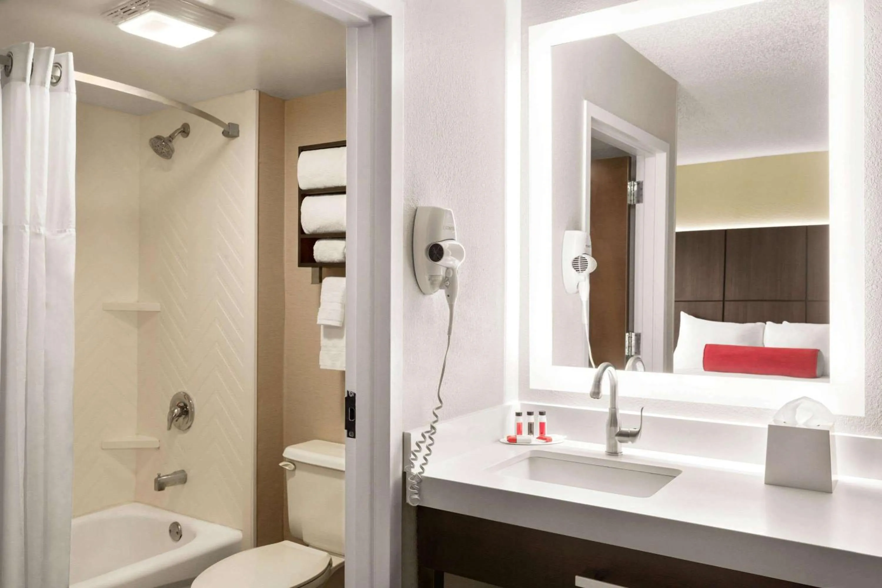 Bathroom in Ramada by Wyndham Suites Orlando Airport- Free Airport Shuttle
