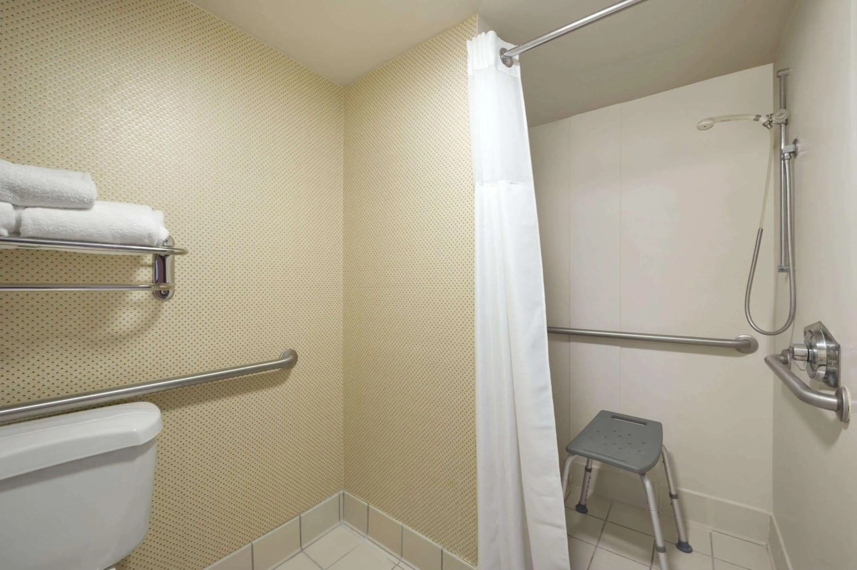 Bathroom in Ramada by Wyndham Suites Orlando Airport- Free Airport Shuttle