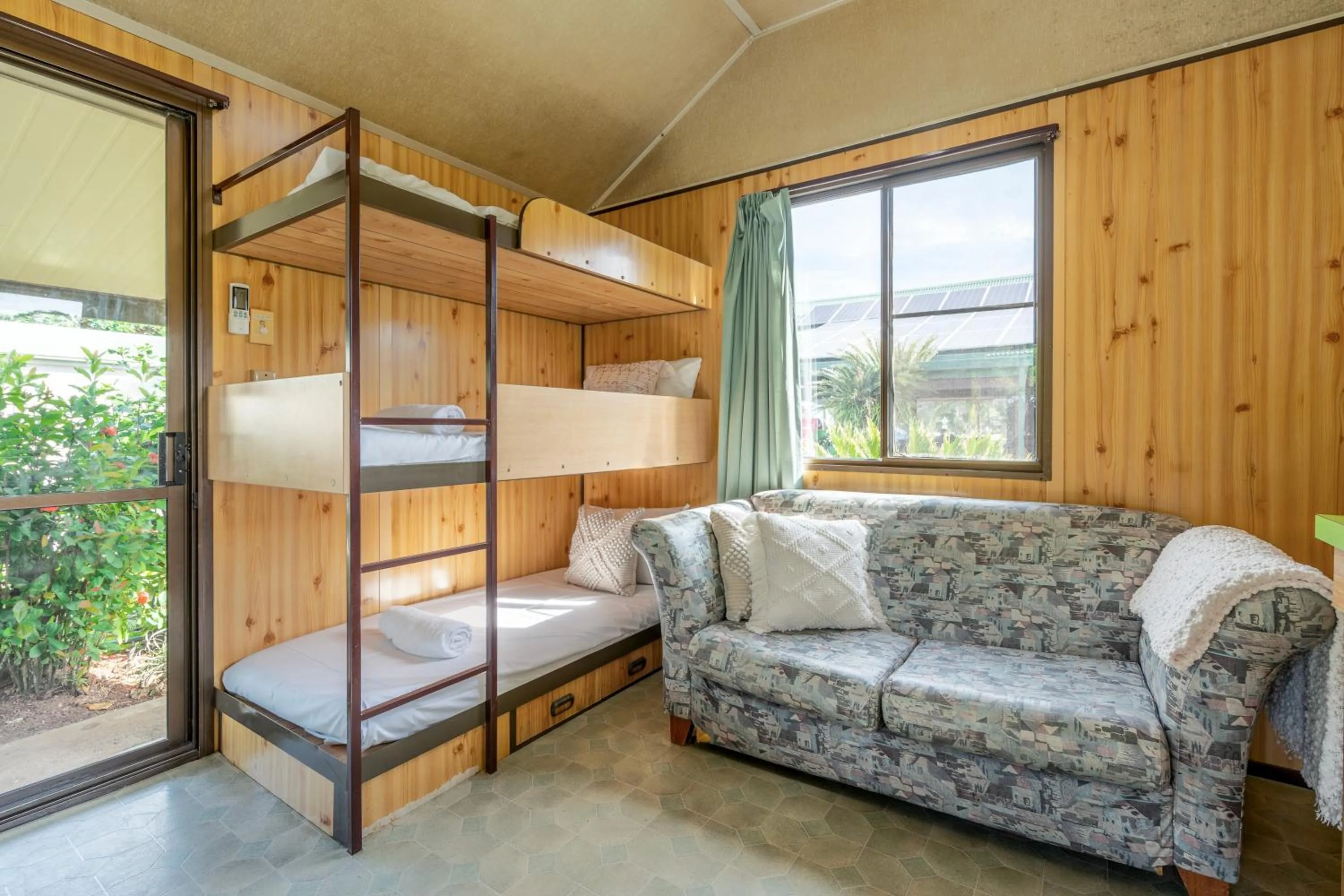 Living room, Bed in BIG4 Tasman Holiday Parks - South Mission Beach