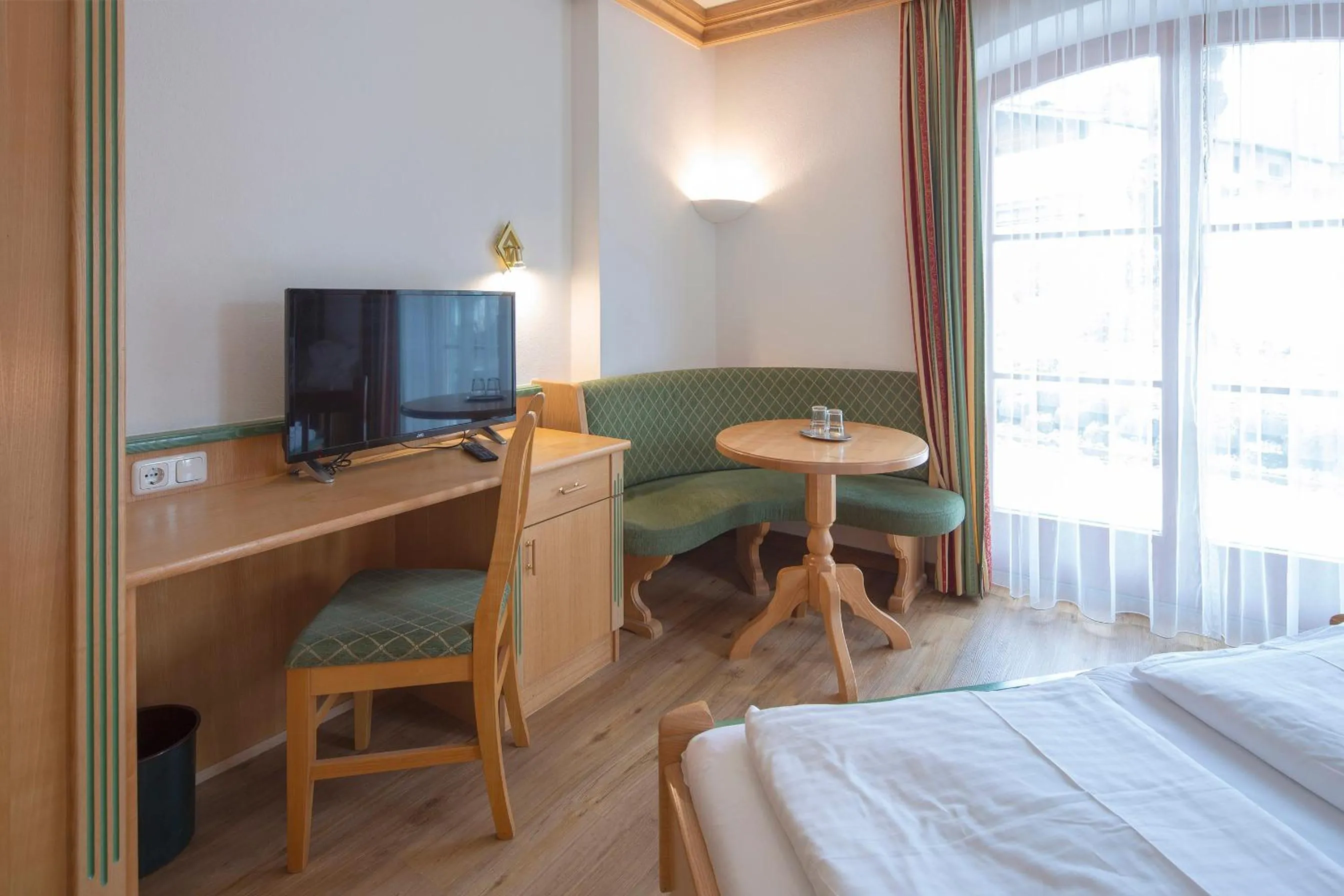 Seating area, Bed in Hotel Gasthof Obermair