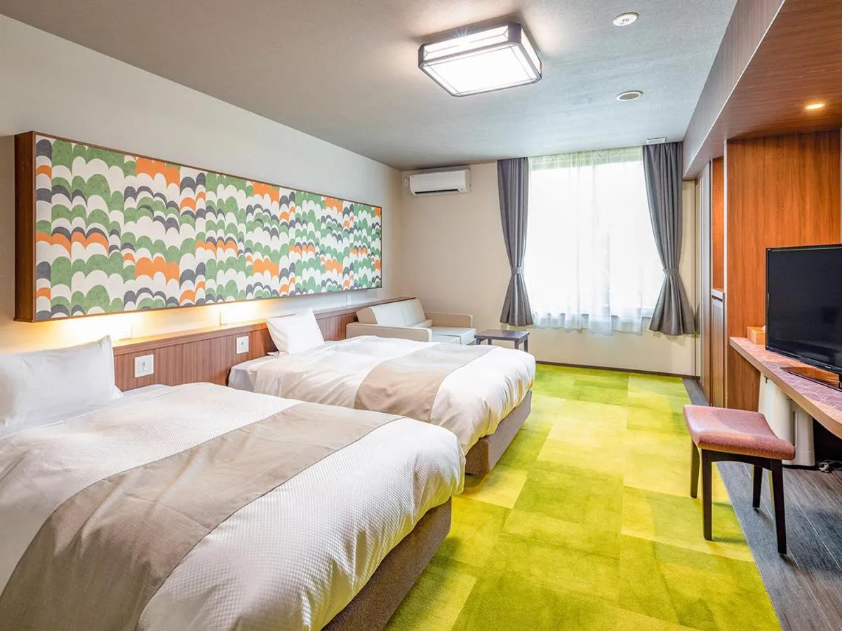 Bed in Ooedo Onsen Monogatari Amakusa Hotel Kameya